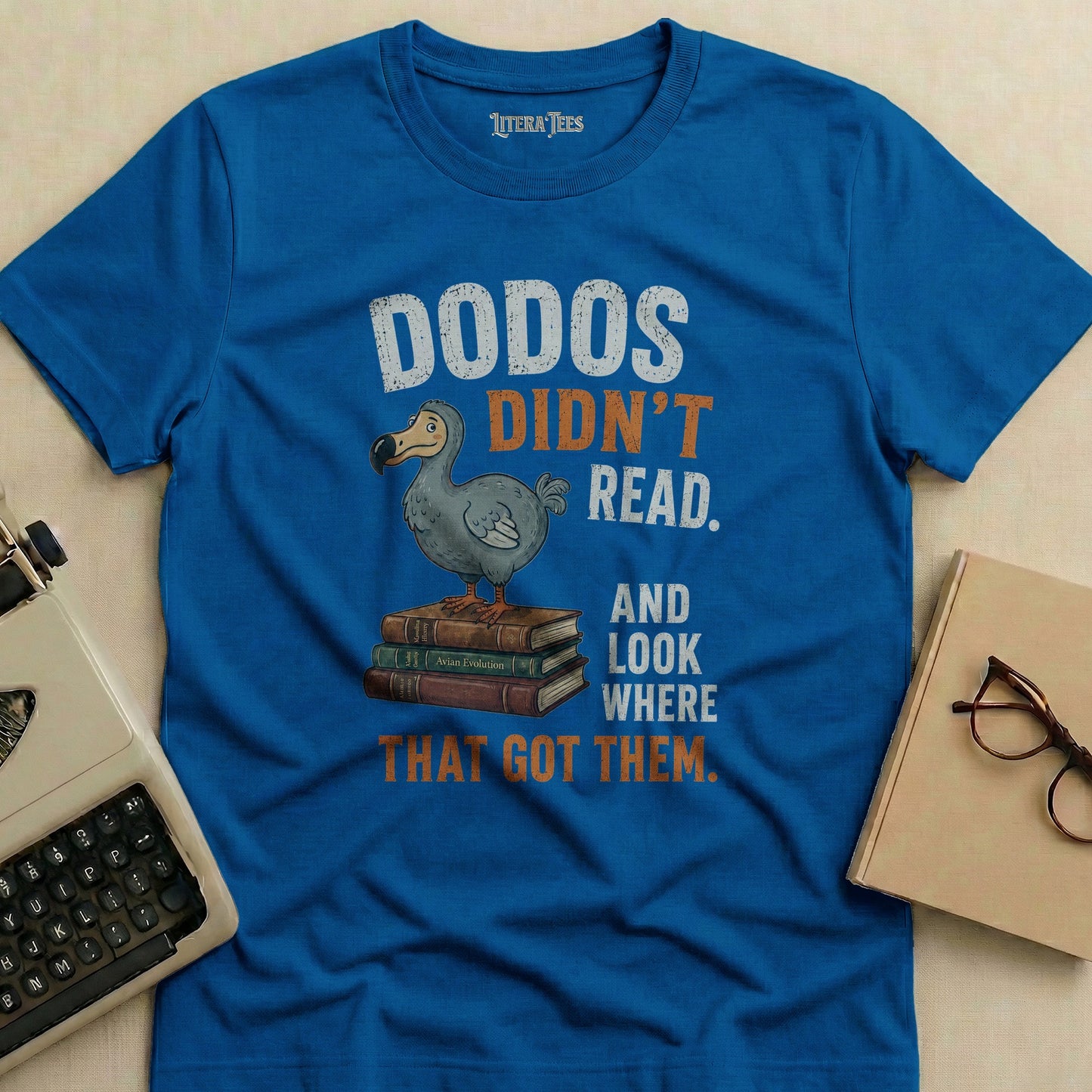 Blue t-shirt with "Dodos Didn't Read" graphic and text.