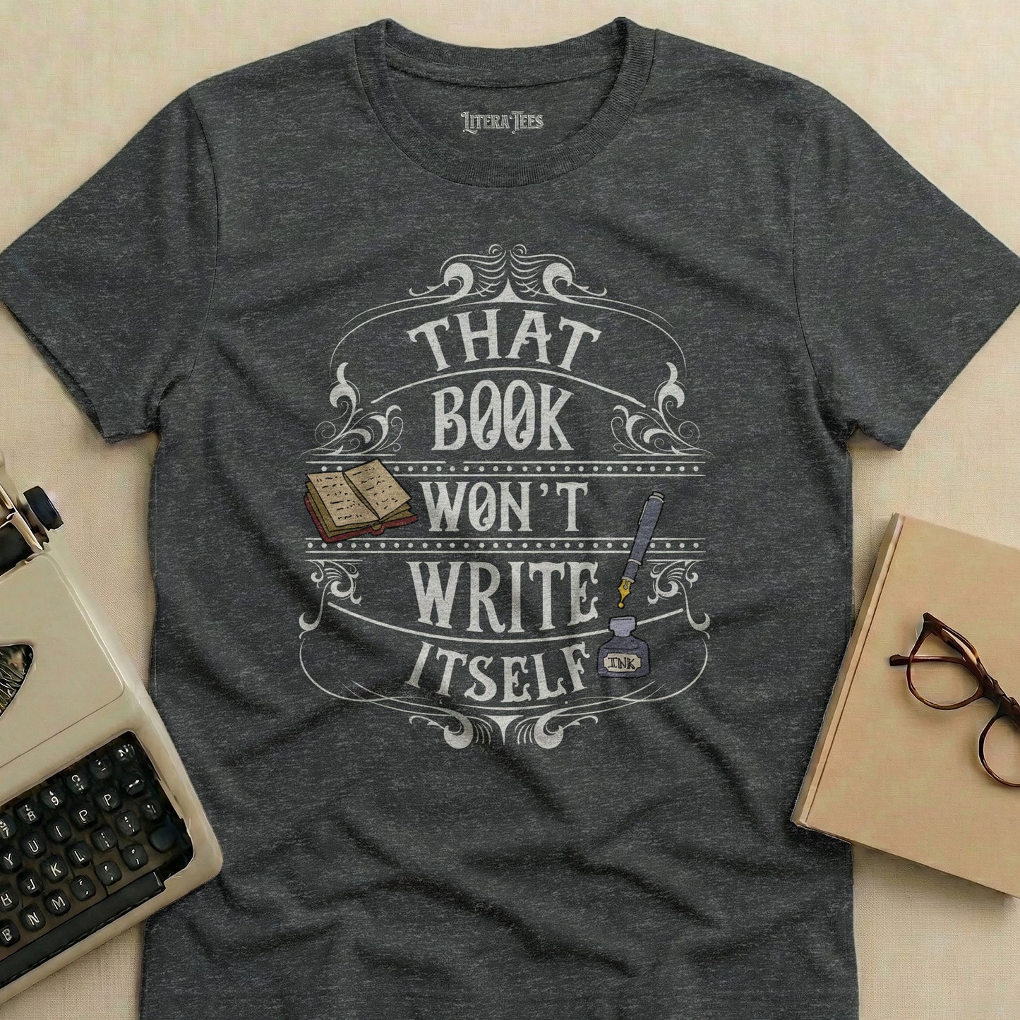 Dark grey t-shirt with "That Book Won't Write Itself" text design.