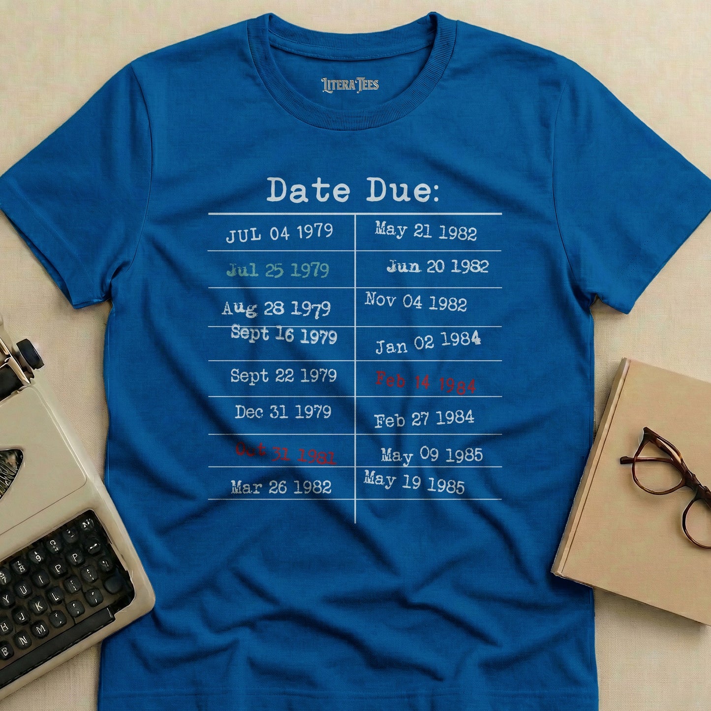 Blue t-shirt with "Date Due" and lists of library due dates.