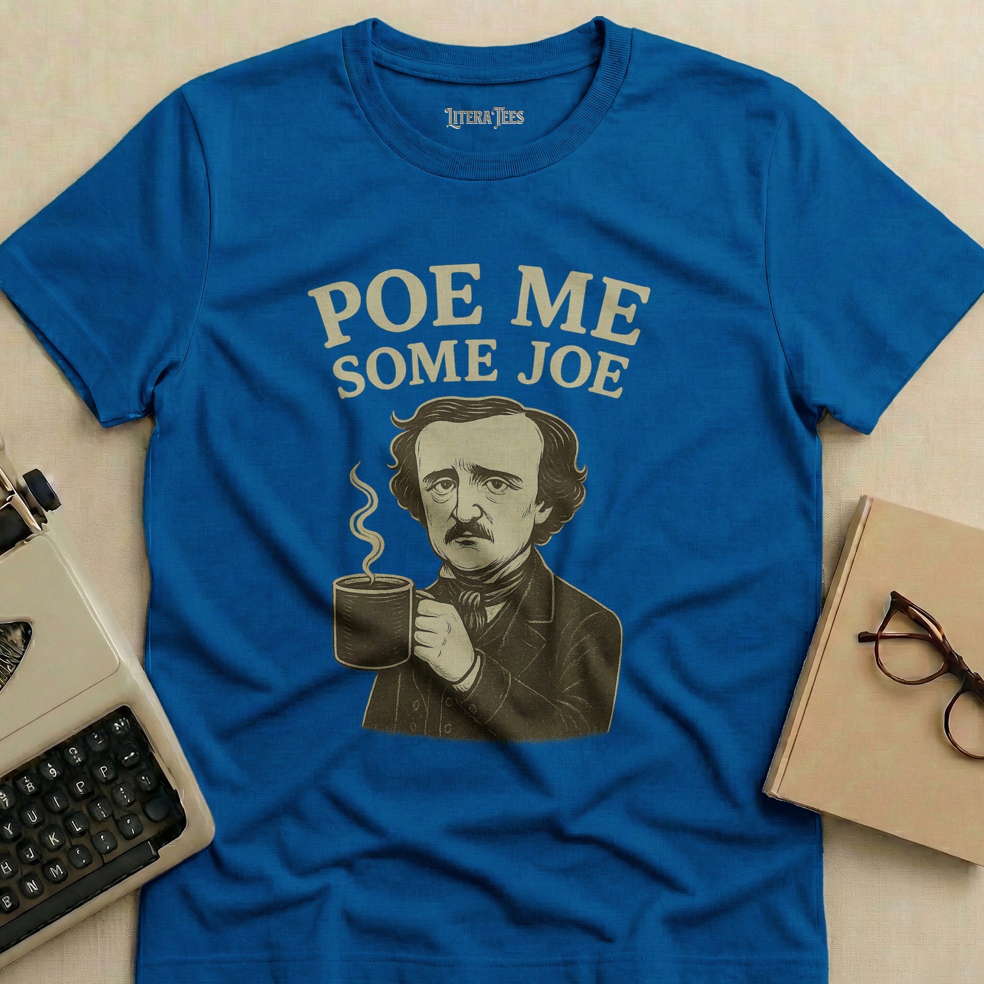 Blue t-shirt with Edgar Allan Poe holding coffee and text "Poe Me Some Joe".