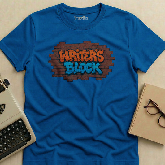 Blue t-shirt with "Writer's Block" graffiti-style text on brick.