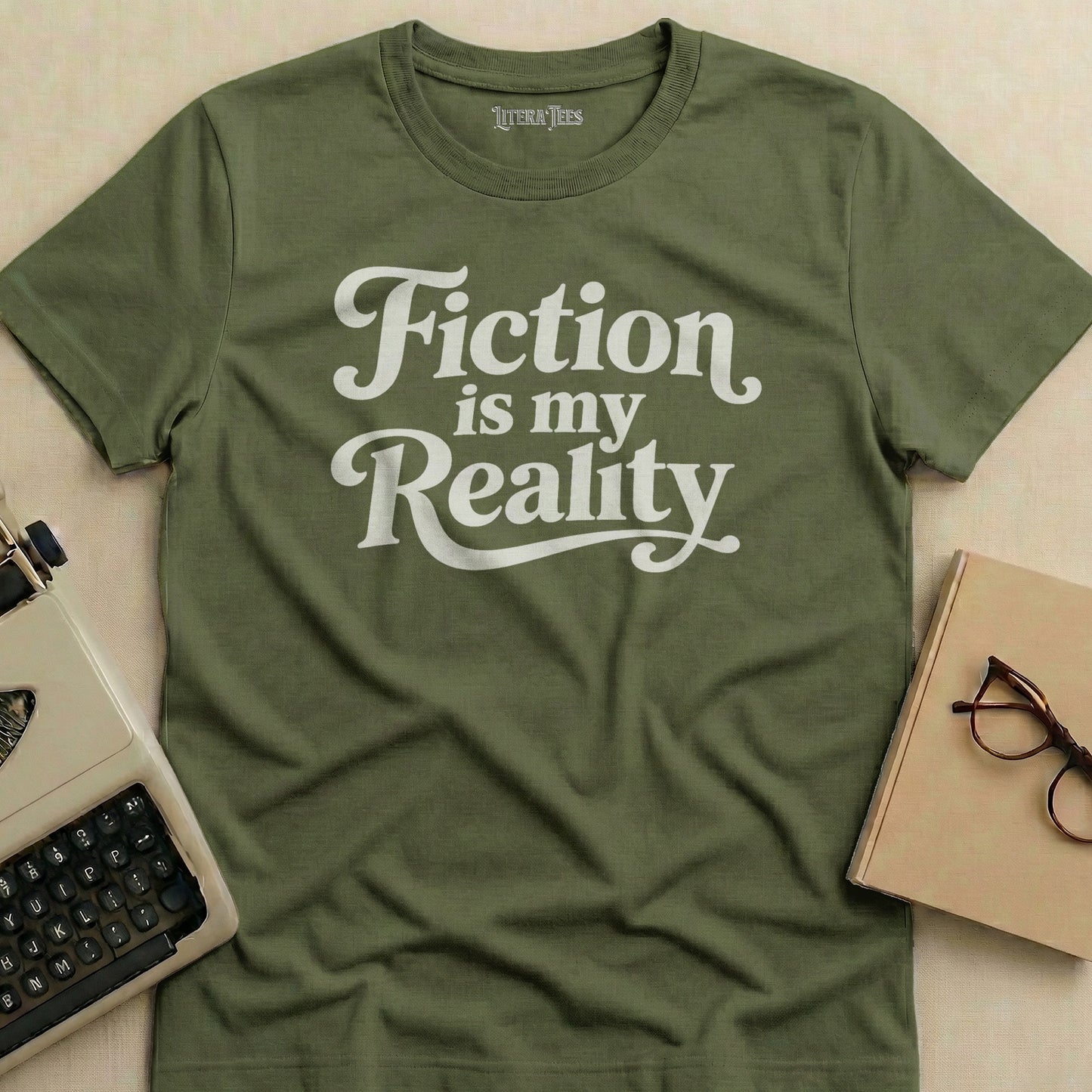Olive green t-shirt with "Fiction is my Reality" in white script.