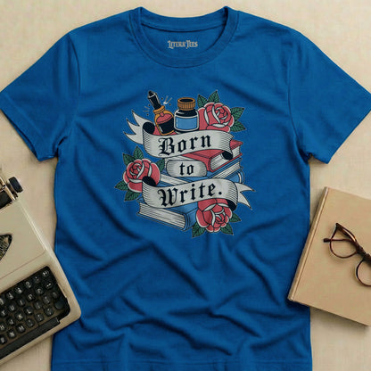 Blue t-shirt with "Born to Write" text, books, roses, and ink bottle graphic.