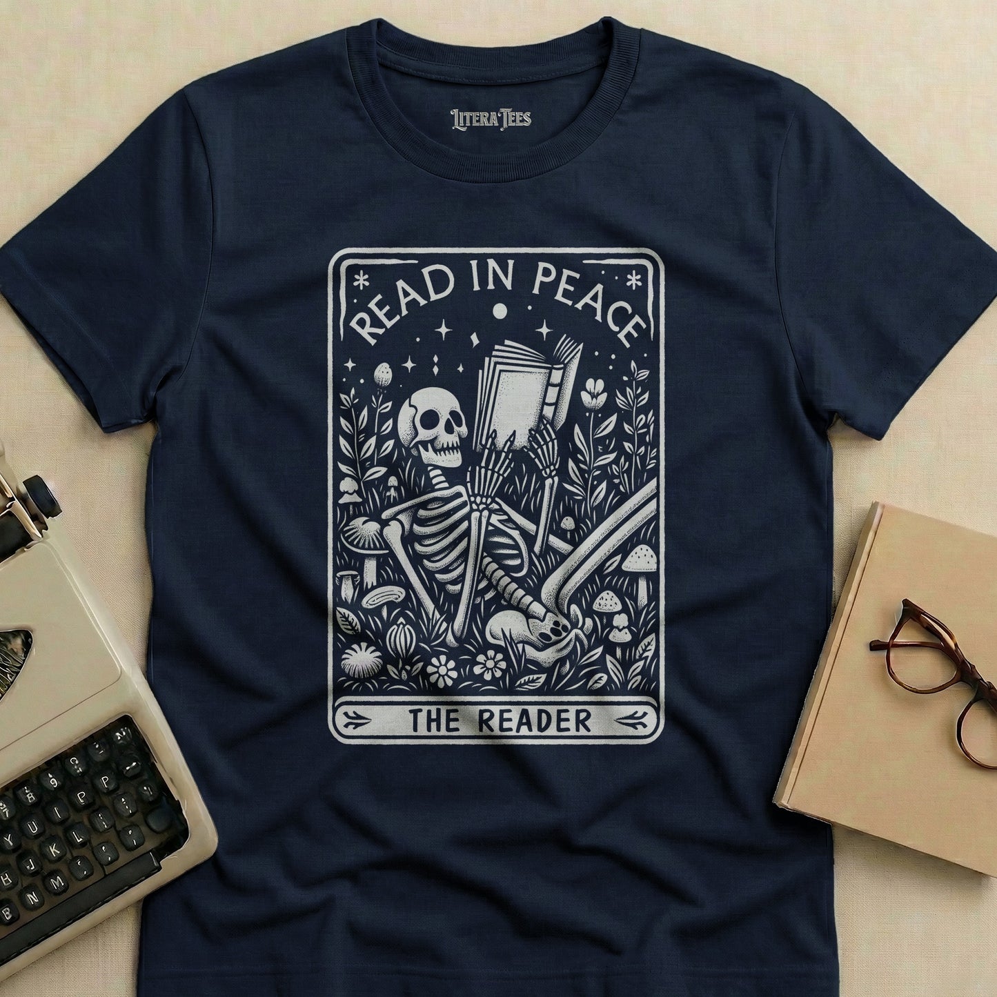 Dark blue t-shirt with "Read in Peace The Reader" skeleton graphic.