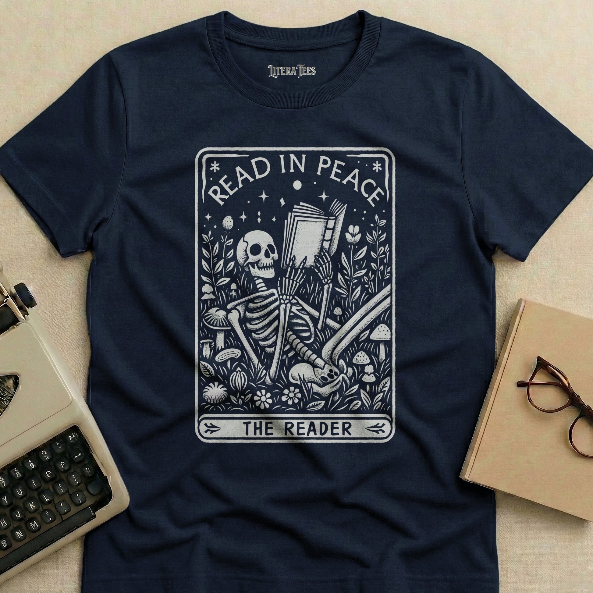 Dark blue t-shirt with "Read in Peace The Reader" skeleton graphic.
