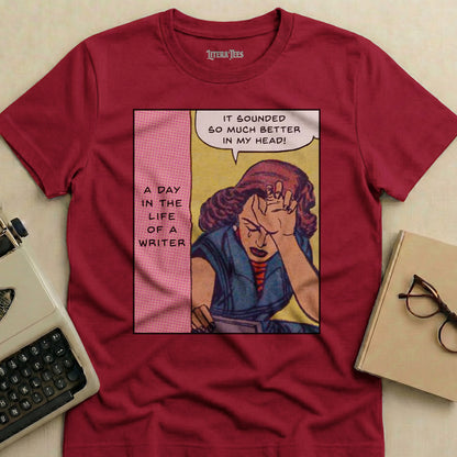 Maroon t-shirt with comic art of a distressed woman and text: "A Day in the Life of a Writer. It sounded so much better in my head!"