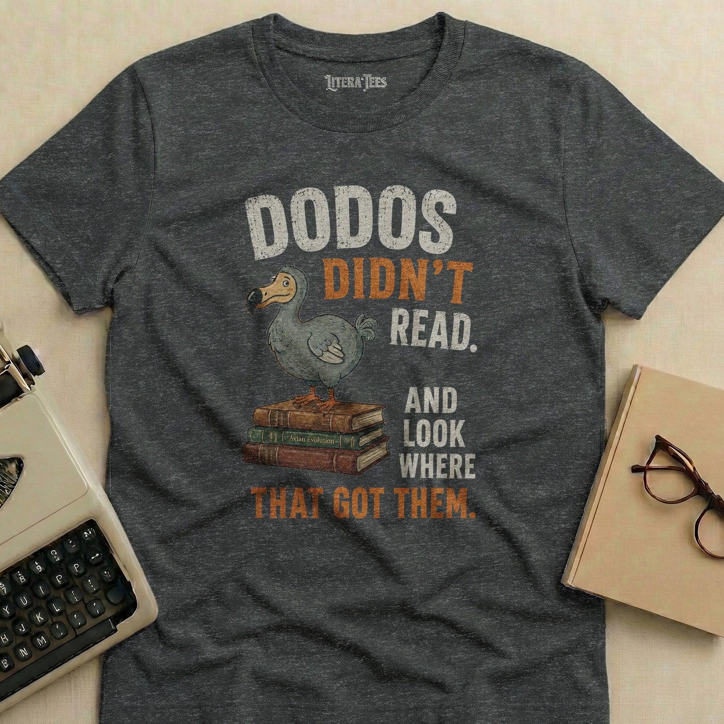 Gray t-shirt with "DODOS DIDN'T READ. AND LOOK WHERE THAT GOT THEM." text.