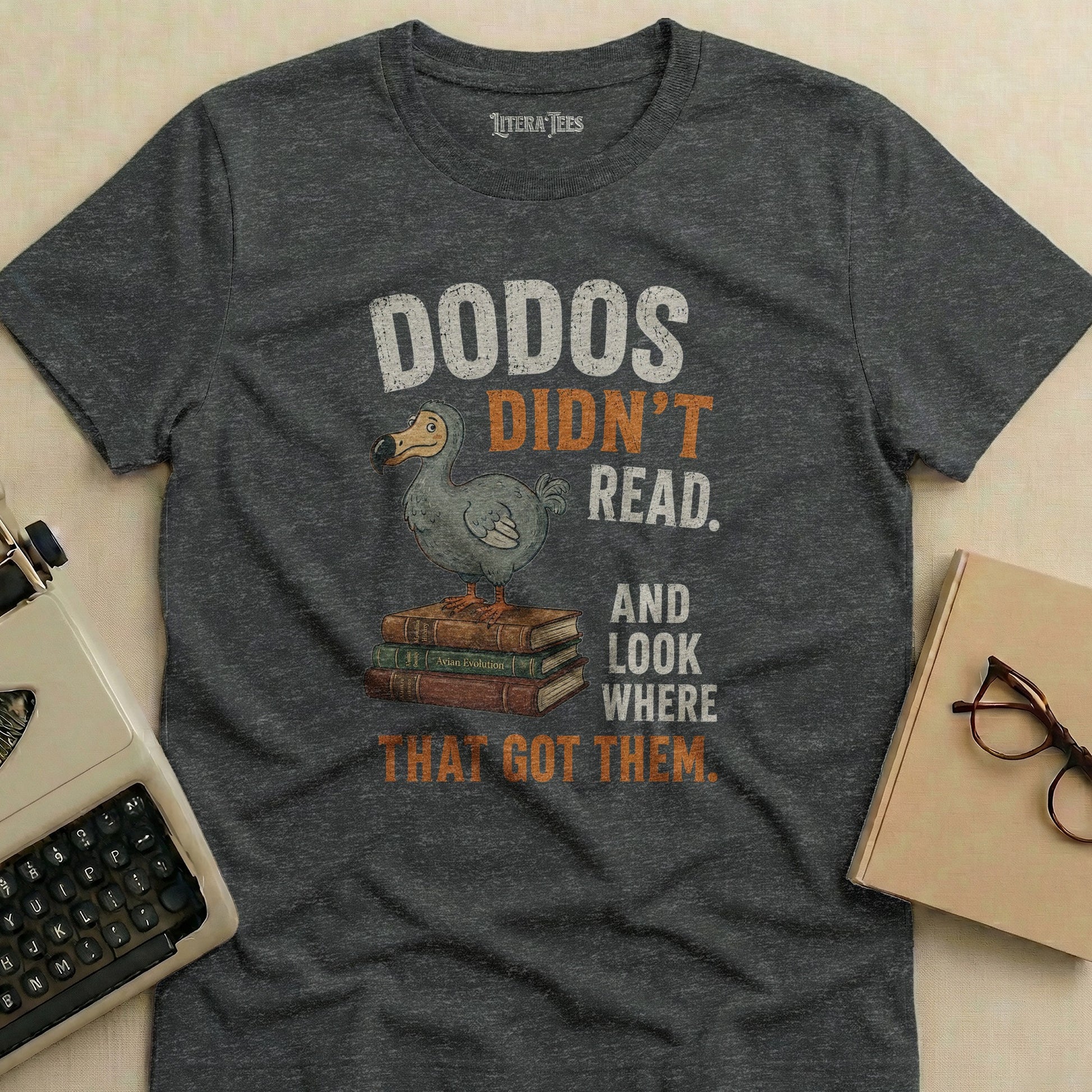 Gray t-shirt with "DODOS DIDN'T READ. AND LOOK WHERE THAT GOT THEM." text.