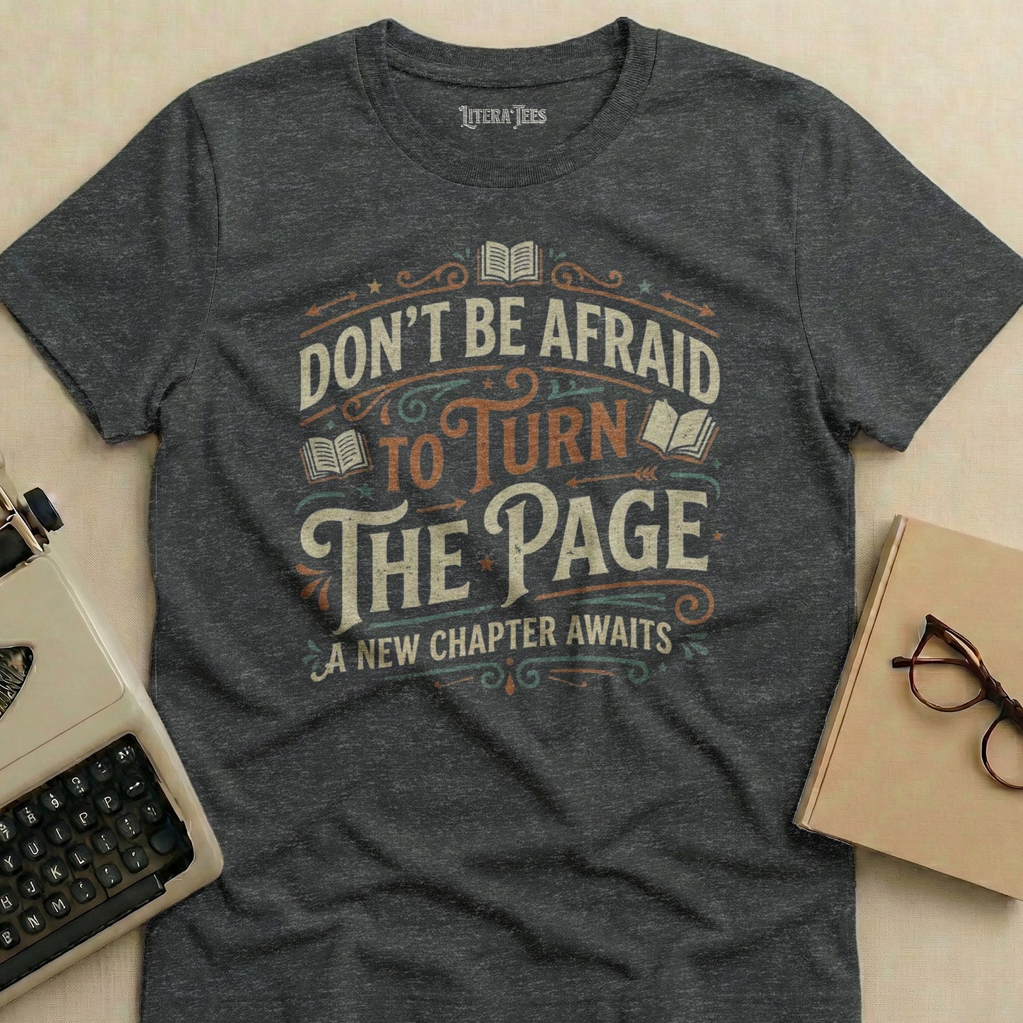 Dark gray t-shirt with "Don't Be Afraid To Turn The Page A New Chapter Awaits" text.