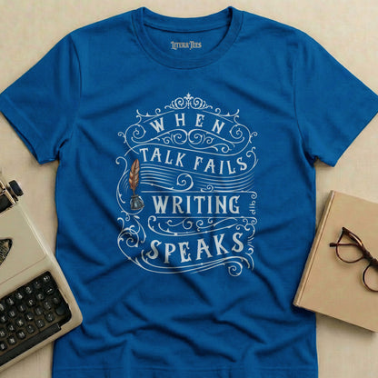 Blue t-shirt with "When Talk Fails Writing Speaks" text and quill design.
