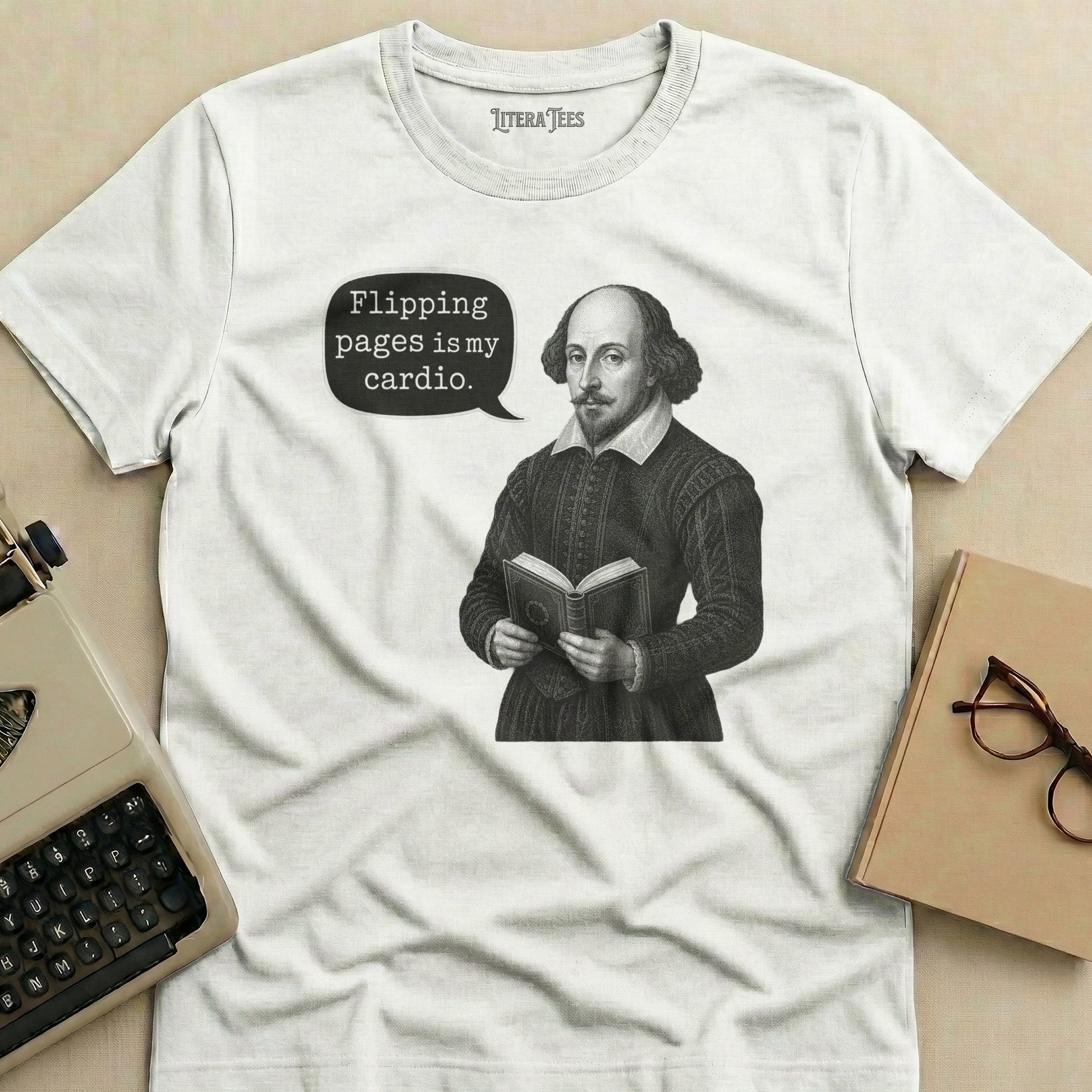 White t-shirt with Shakespeare reading a book and the text "Flipping pages is my cardio."