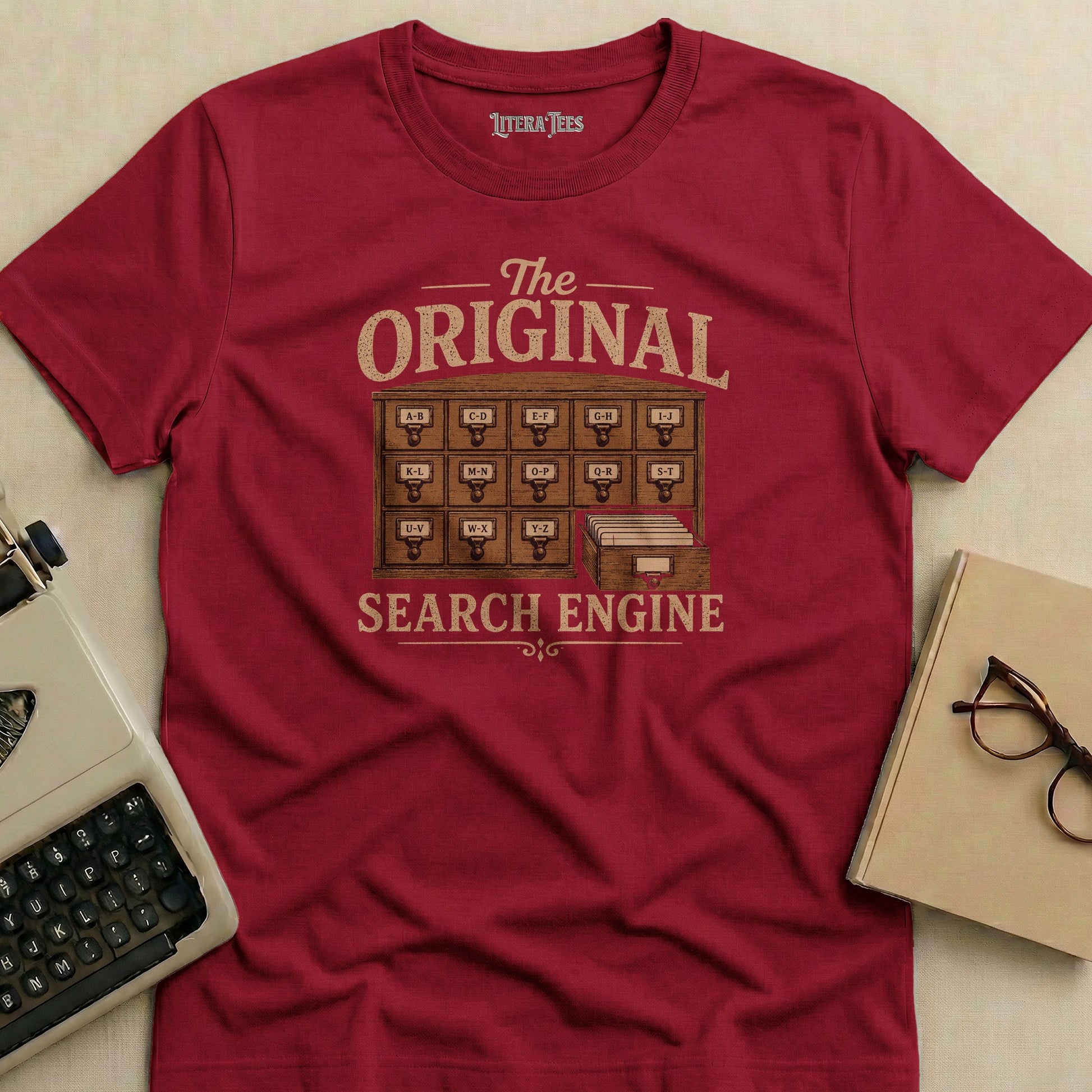 Maroon t-shirt with "The ORIGINAL SEARCH ENGINE" and library card catalog.