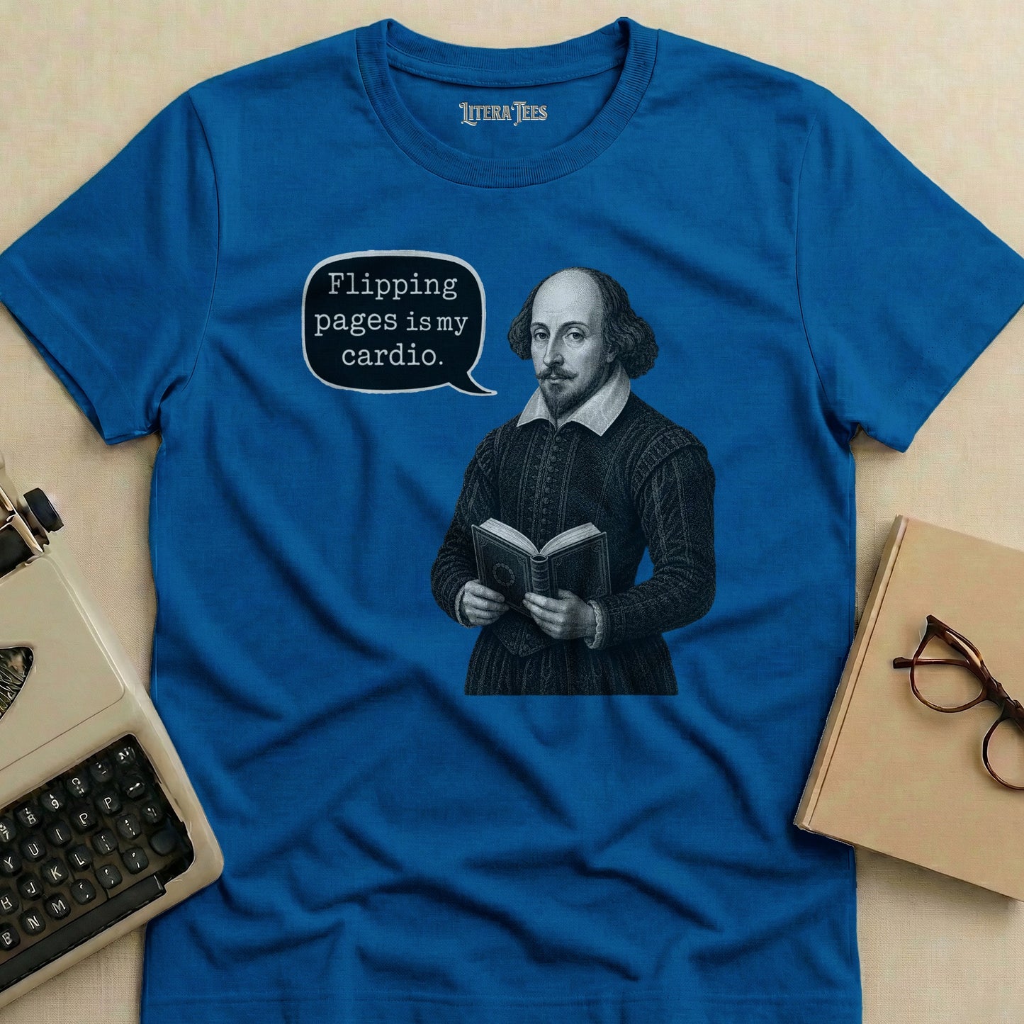 Blue t-shirt with Shakespeare reading a book and text bubble saying "Flipping pages is my cardio."
