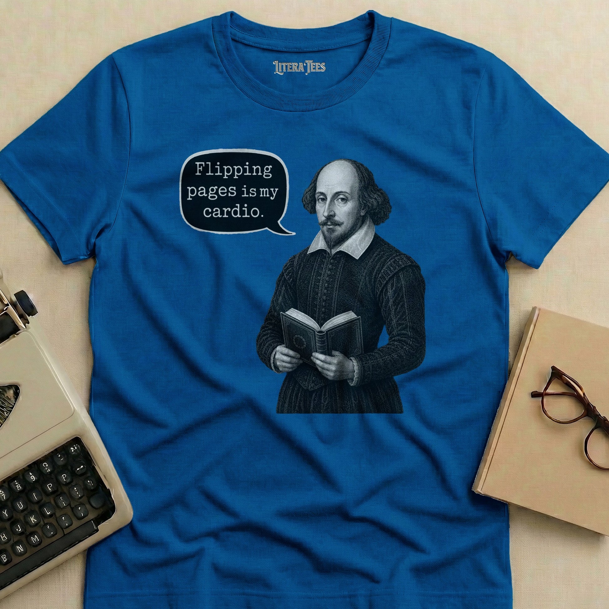 Blue t-shirt with Shakespeare reading a book and text bubble saying "Flipping pages is my cardio."