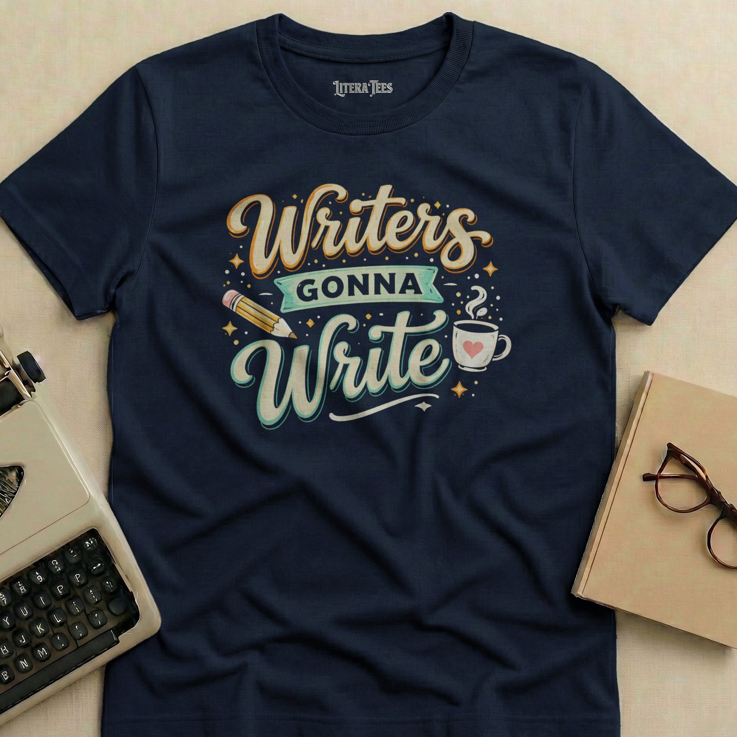 Navy t-shirt with "Writers Gonna Write" design and a pencil and coffee cup.