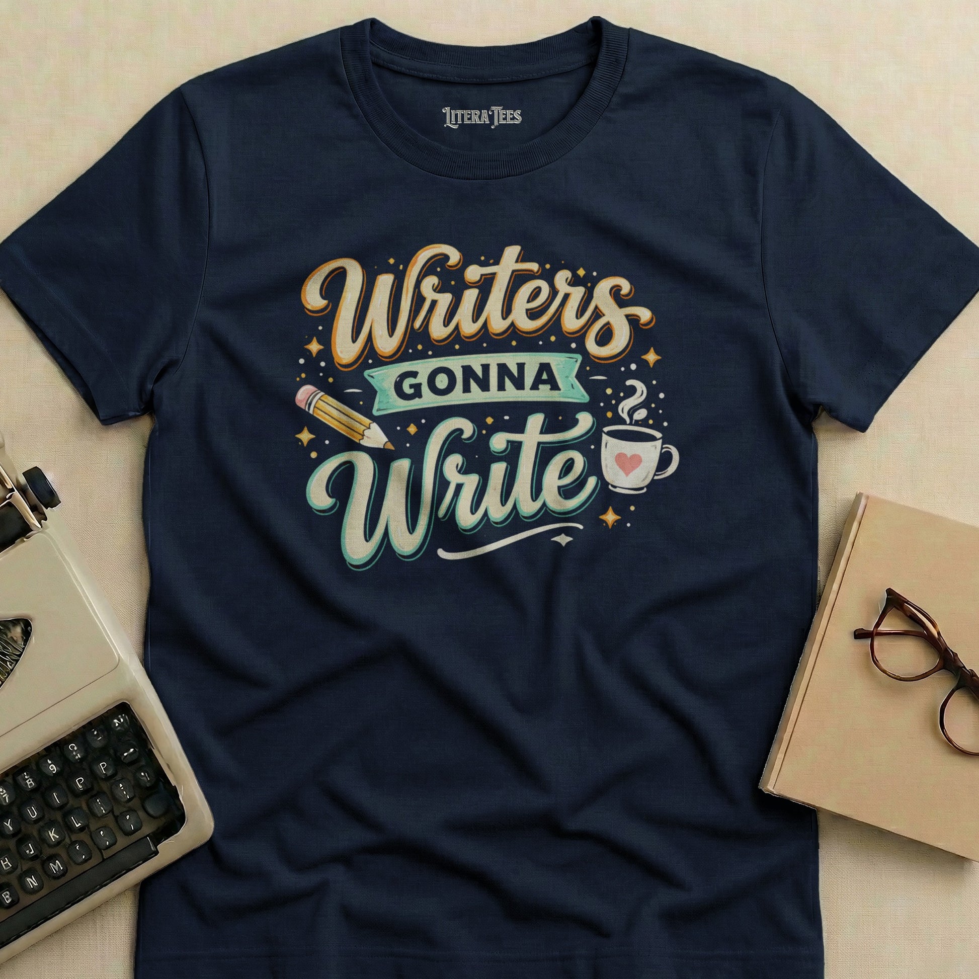 Navy t-shirt with "Writers Gonna Write" design and a pencil and coffee cup.
