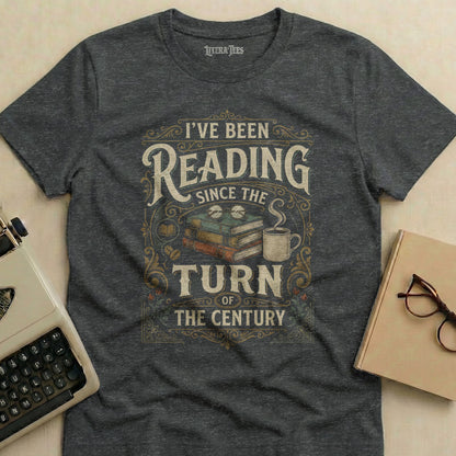 Dark gray t-shirt with "I've Been Reading Since the Turn of the Century" text and vintage design.