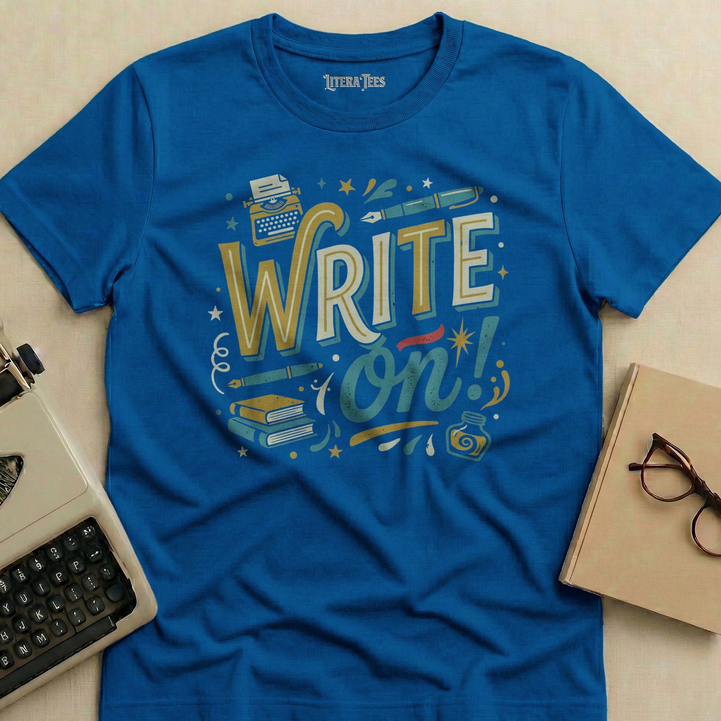 Blue t-shirt with "WRITE on!" text and typewriter graphic.
