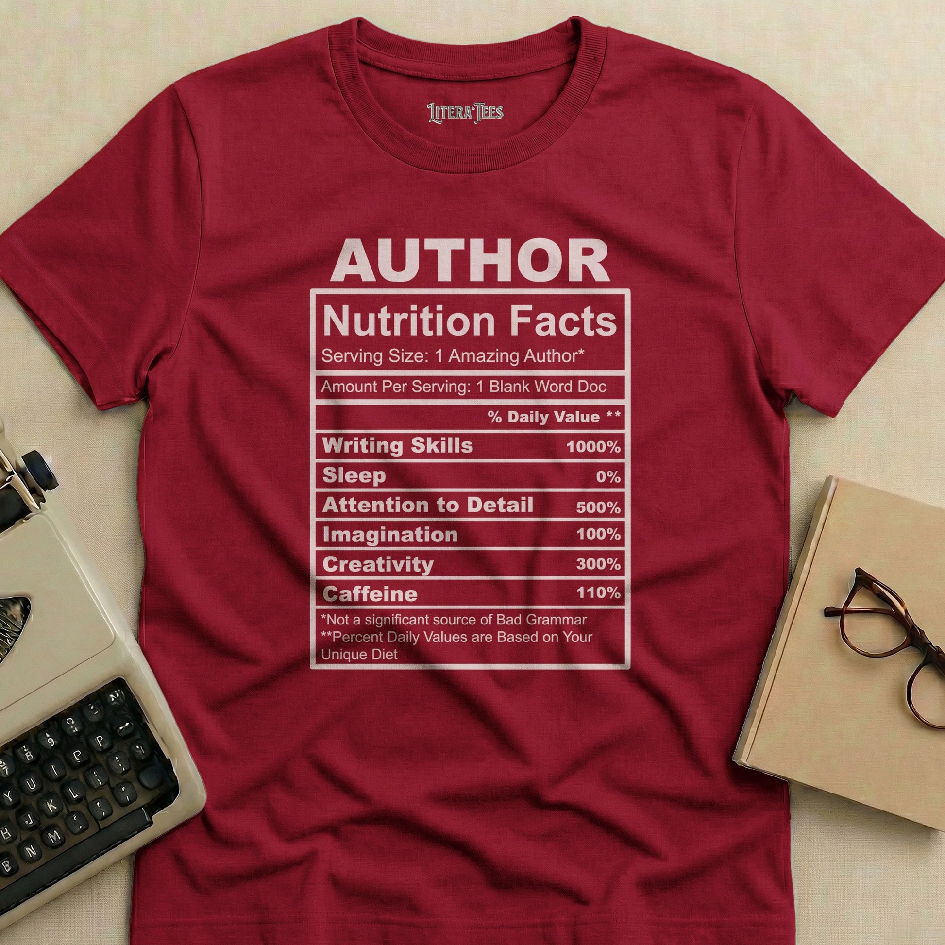T-shirt with "Author Nutrition Facts" label detailing writing skills, sleep, imagination, and caffeine.