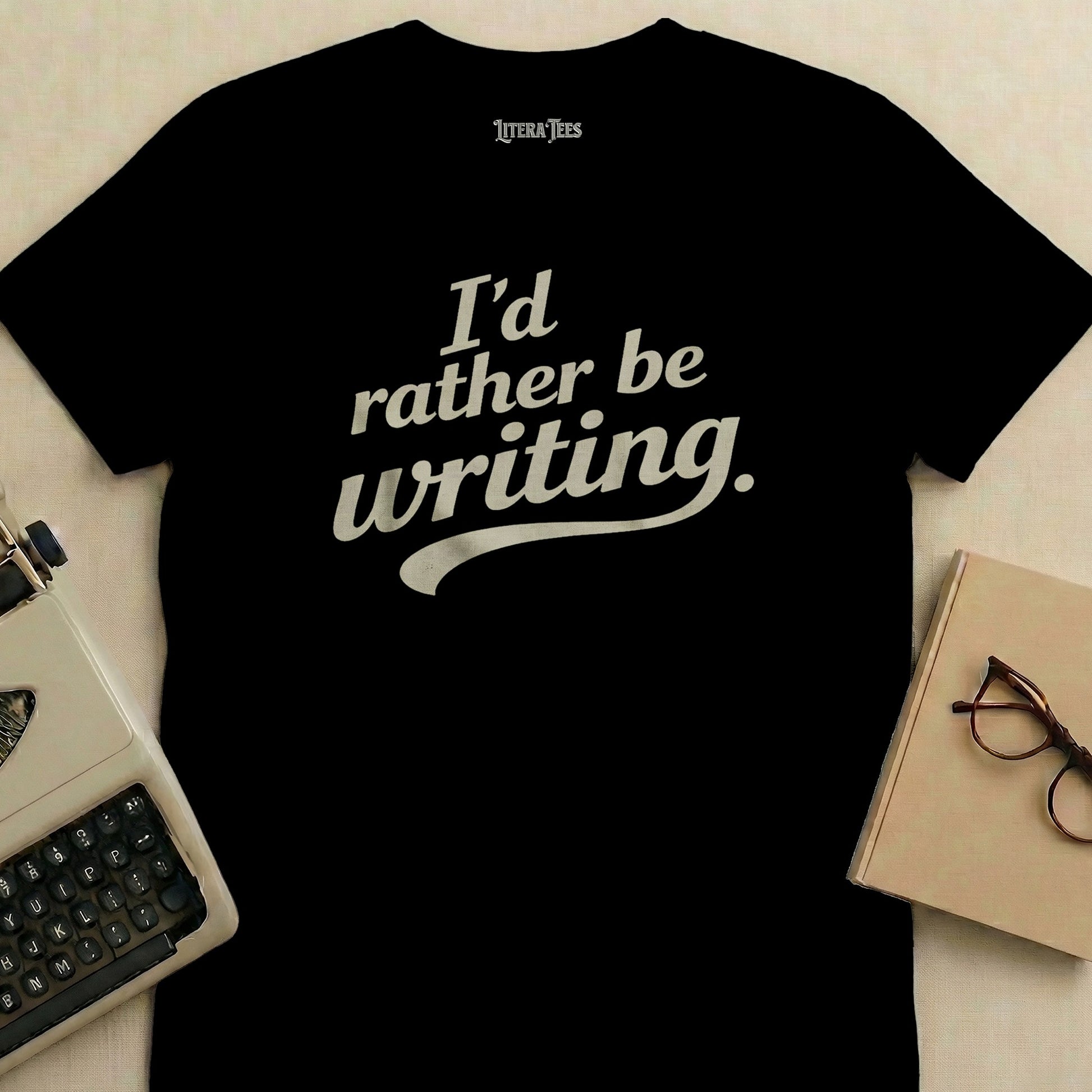 Black t-shirt with "I'd rather be writing." in white cursive.