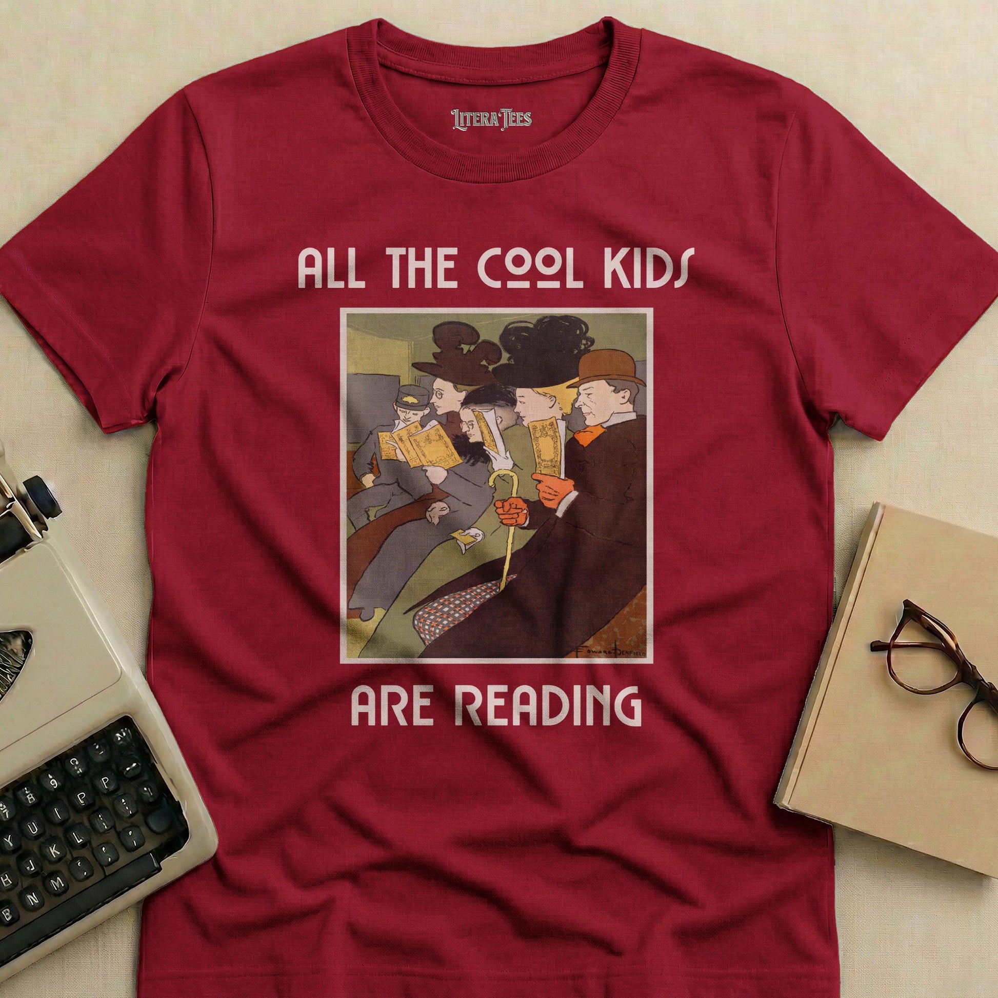 Maroon t-shirt with "ALL THE COOL KIDS ARE READING" and vintage illustration.