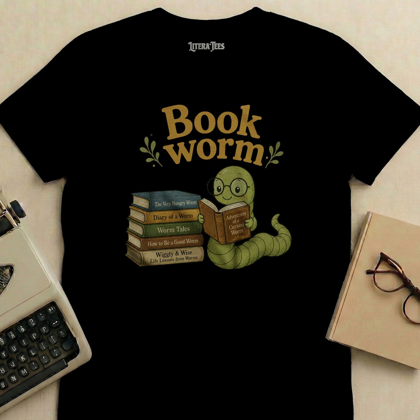 Black t-shirt with cartoon worm reading books, text "Book worm" and Literatees.