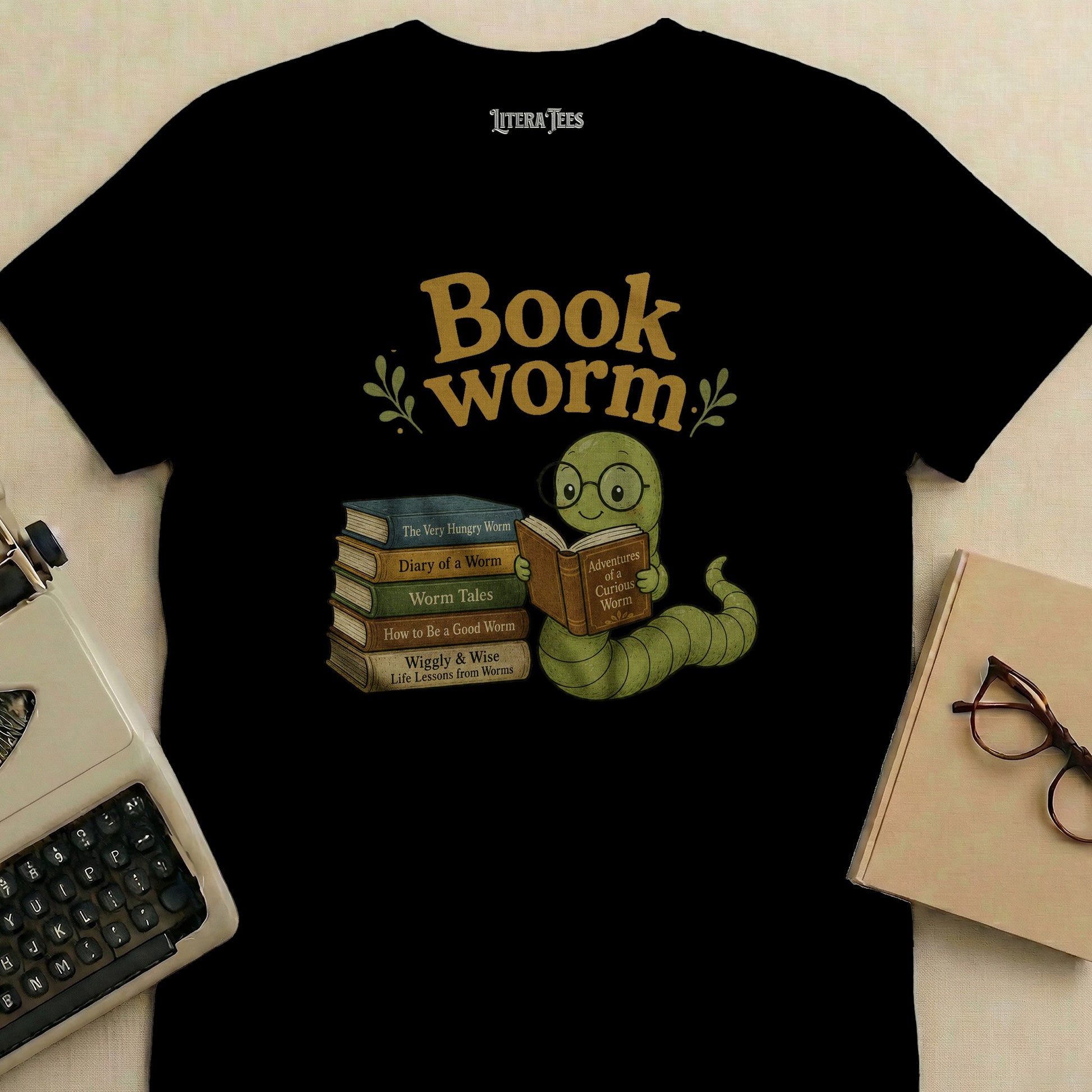 Black t-shirt with cartoon worm reading books, text "Book worm" and Literatees.