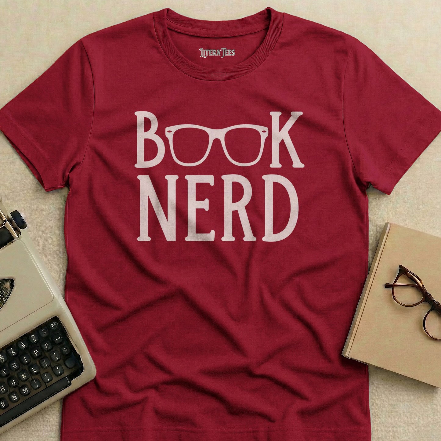 Crimson t-shirt with white "BOOK NERD" text and glasses graphic.