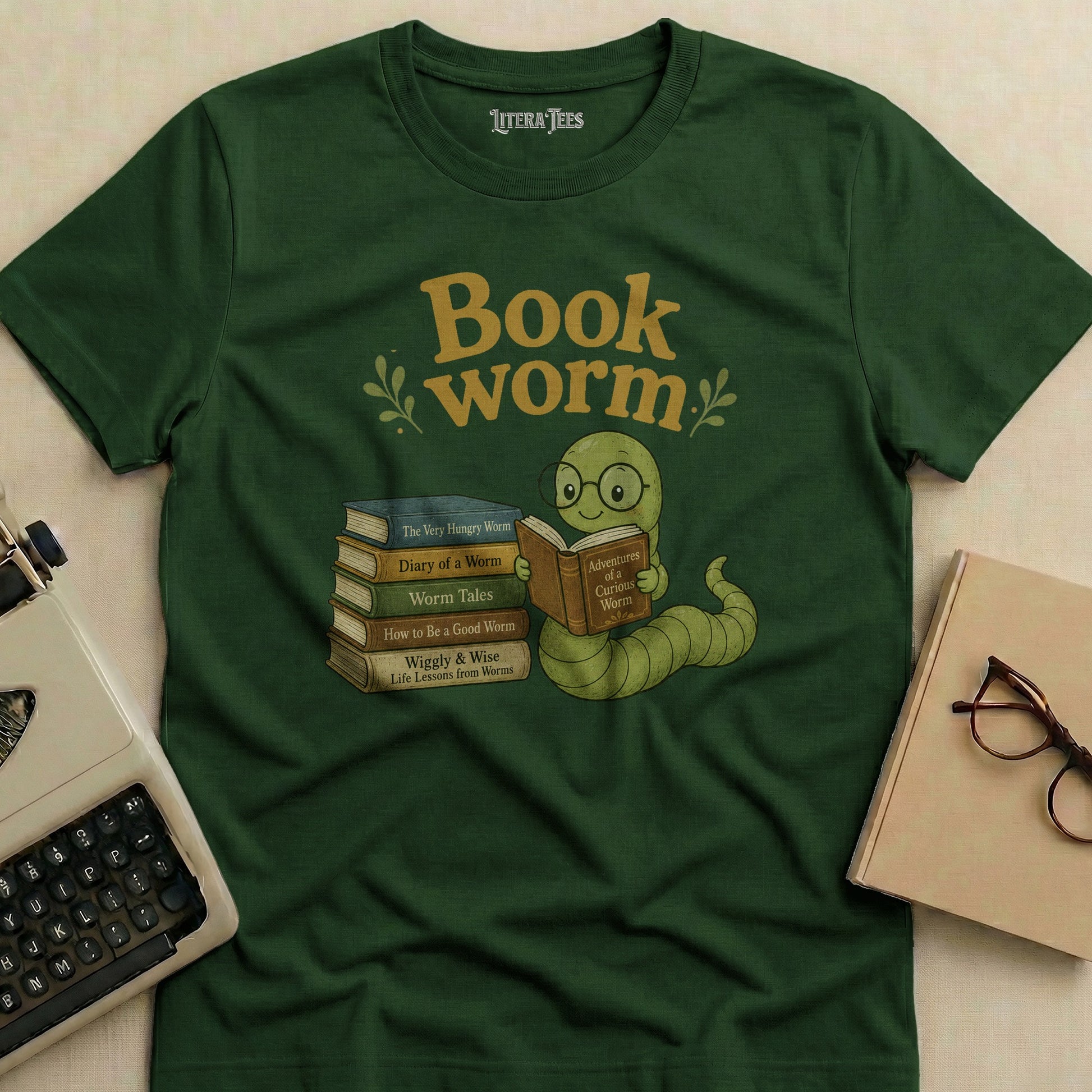 Green t-shirt with a cartoon worm reading a book, surrounded by book titles.