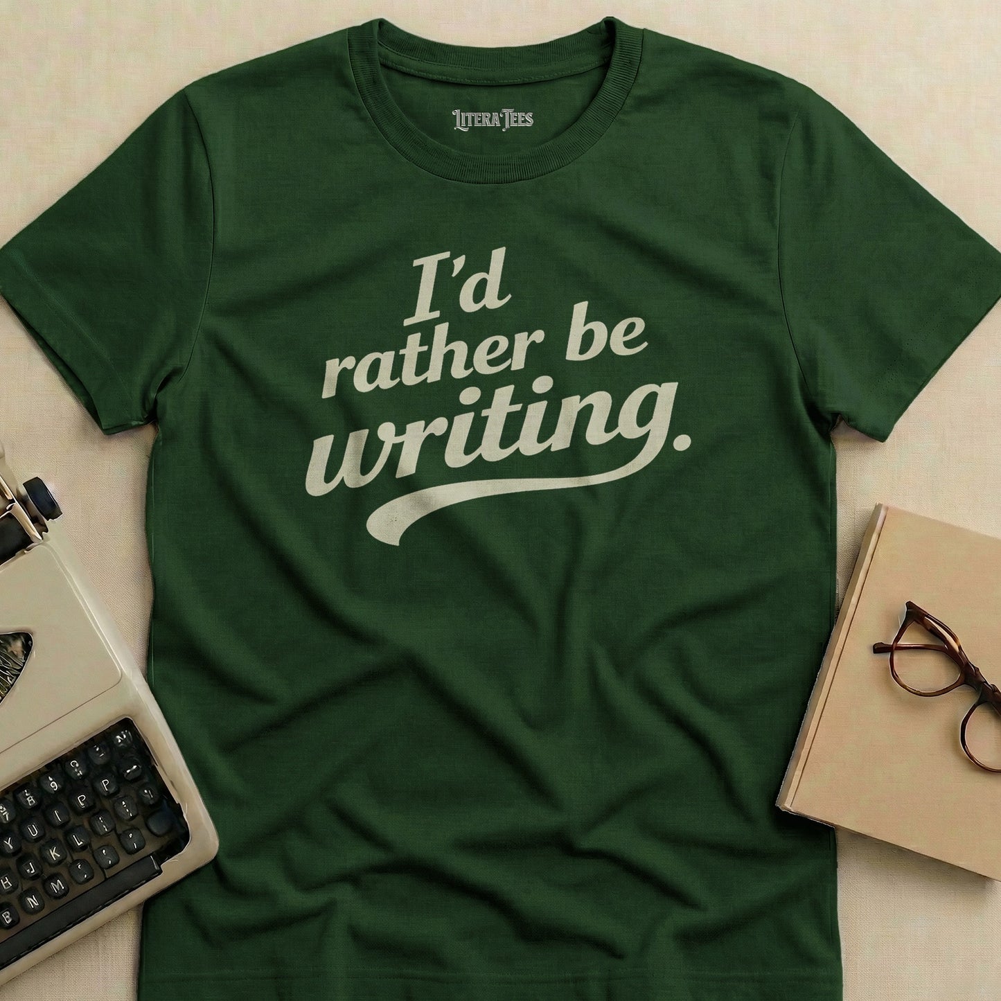 Green t-shirt with "I'd rather be writing." in white text.