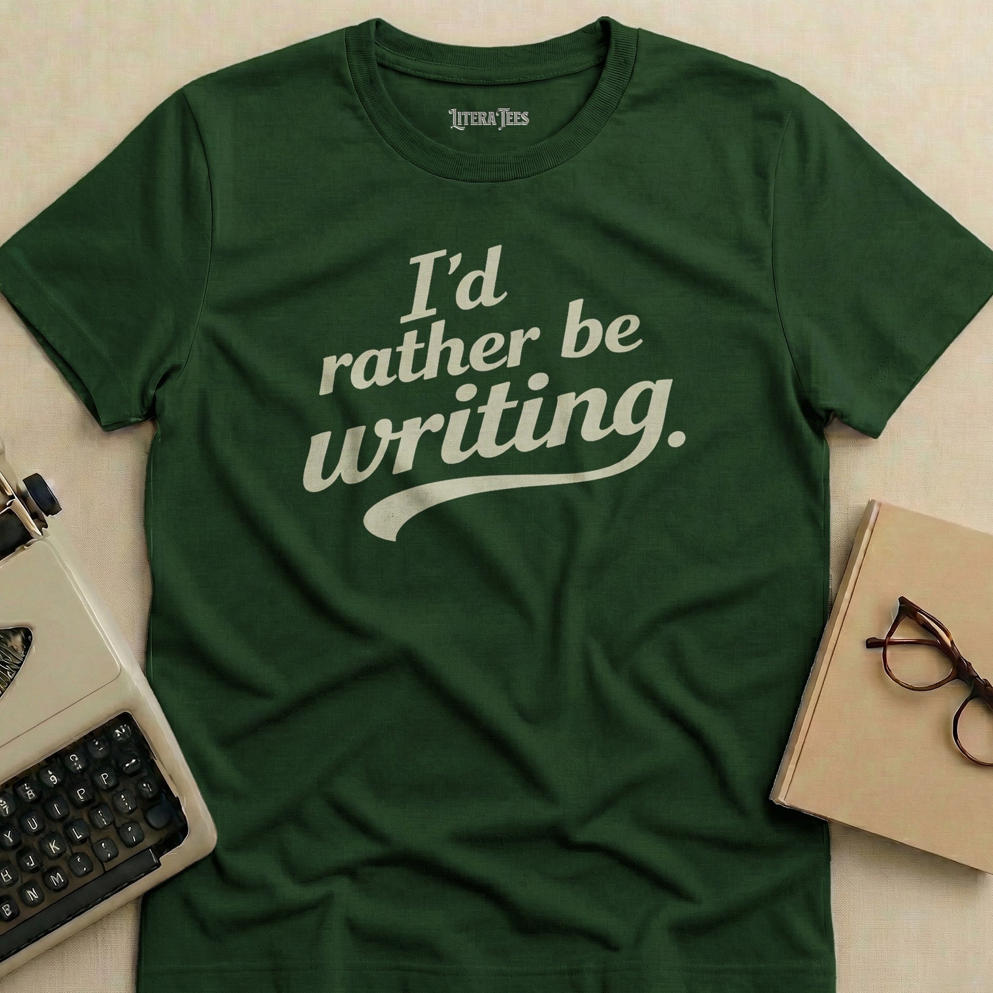 Green t-shirt with "I'd rather be writing." in white text.