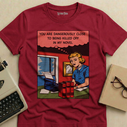 T-shirt with comic panel of woman at desk with typewriter and books.