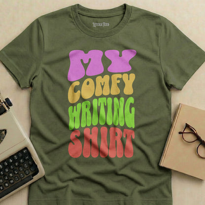 Olive green t-shirt with "MY COMFY WRITING SHIRT" text in colorful letters.