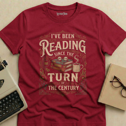 Maroon t-shirt with "I've been reading since the turn of the century" graphic.