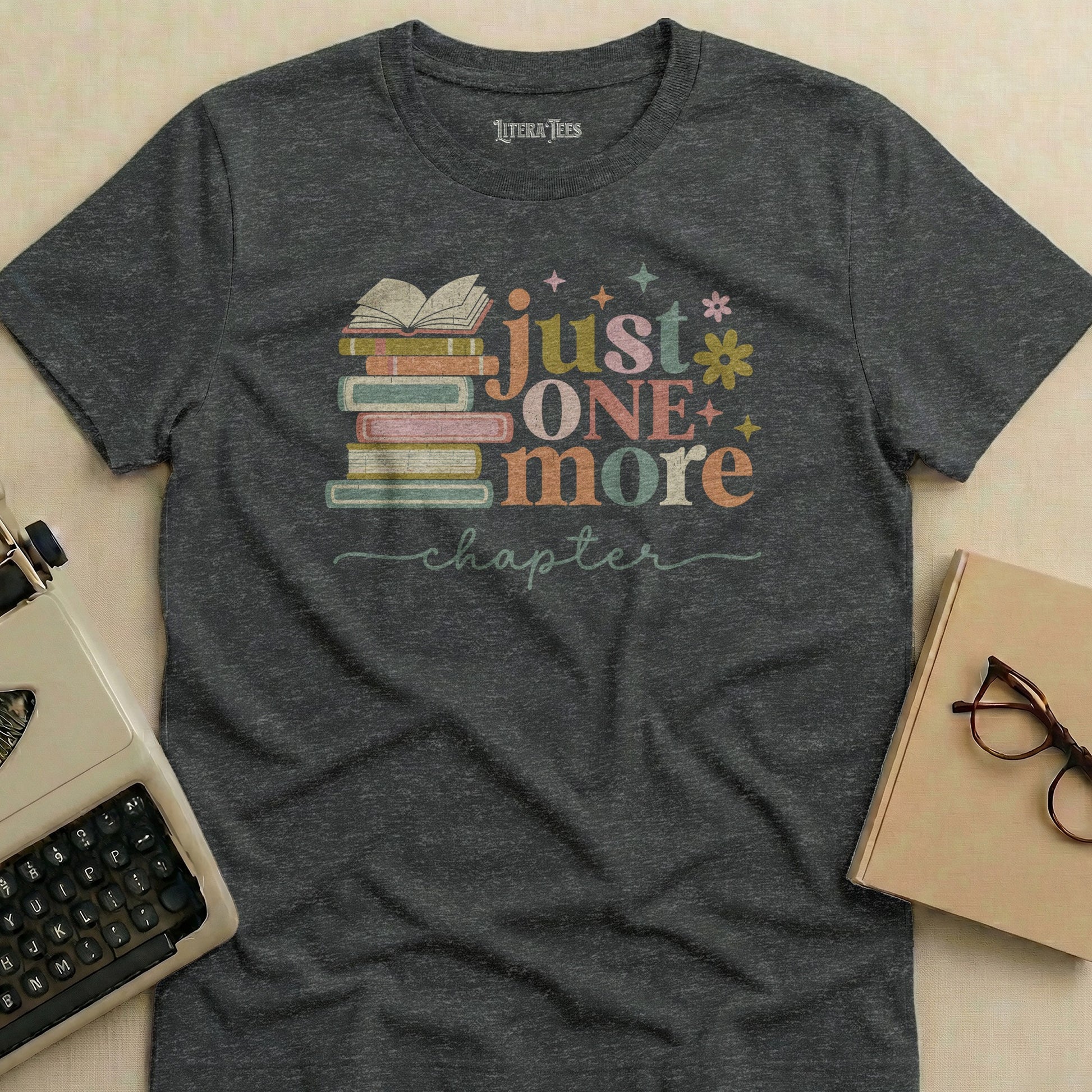 T-shirt with stacked books and "just one more chapter" text.
