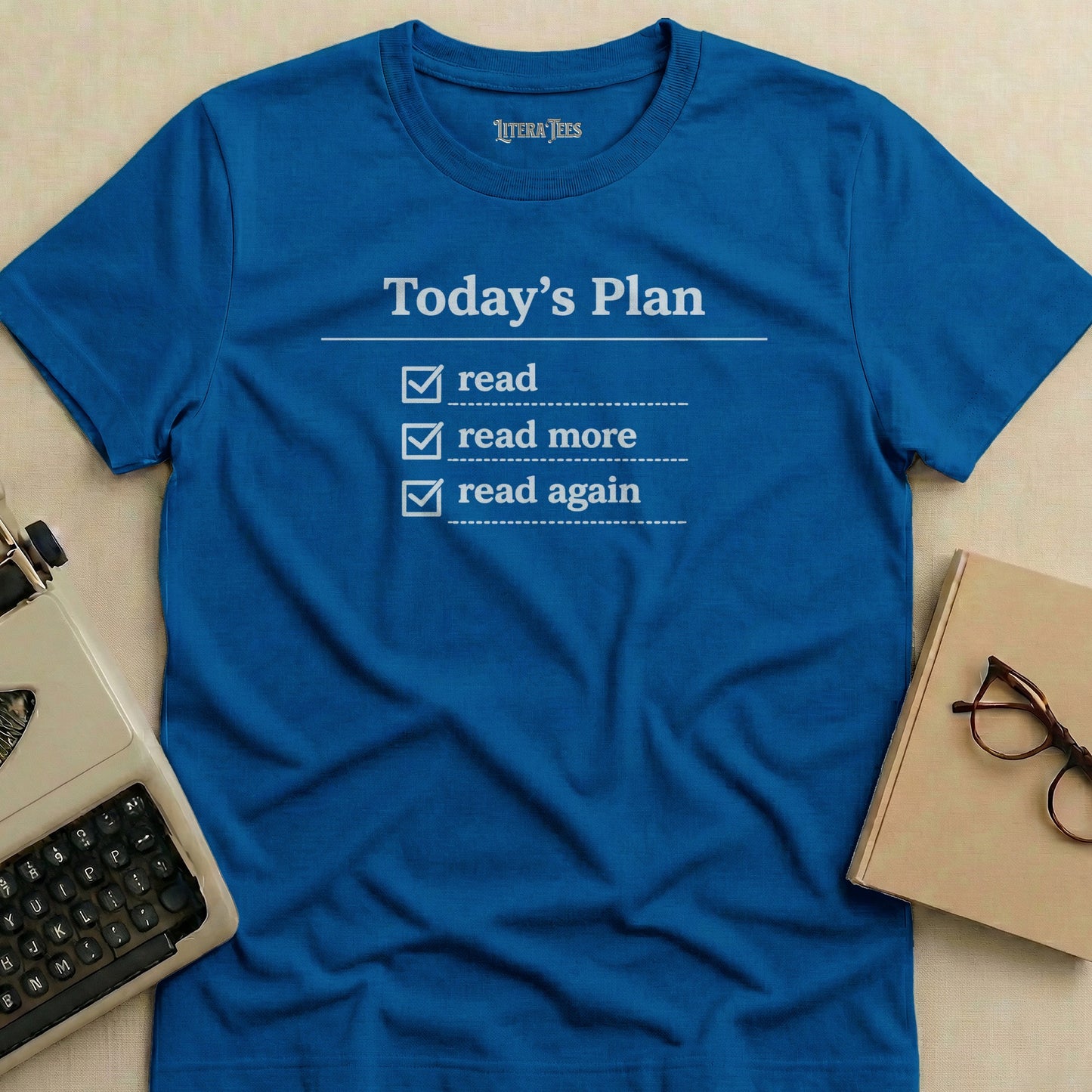 Blue t-shirt with "Today's Plan: read, read more, read again" in white text.