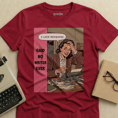 Maroon t-shirt with comic art of a woman at a typewriter saying "I love revisions!"