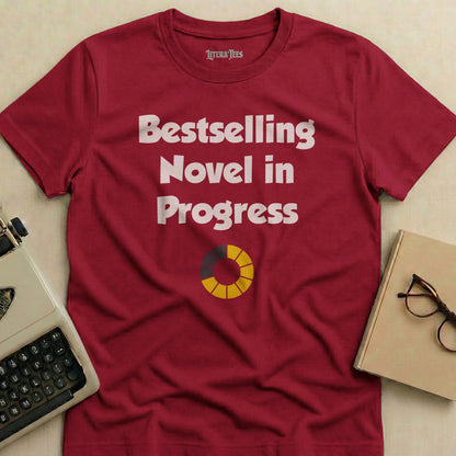 Burgundy t-shirt with "Bestselling Novel in Progress" text and progress circle.
