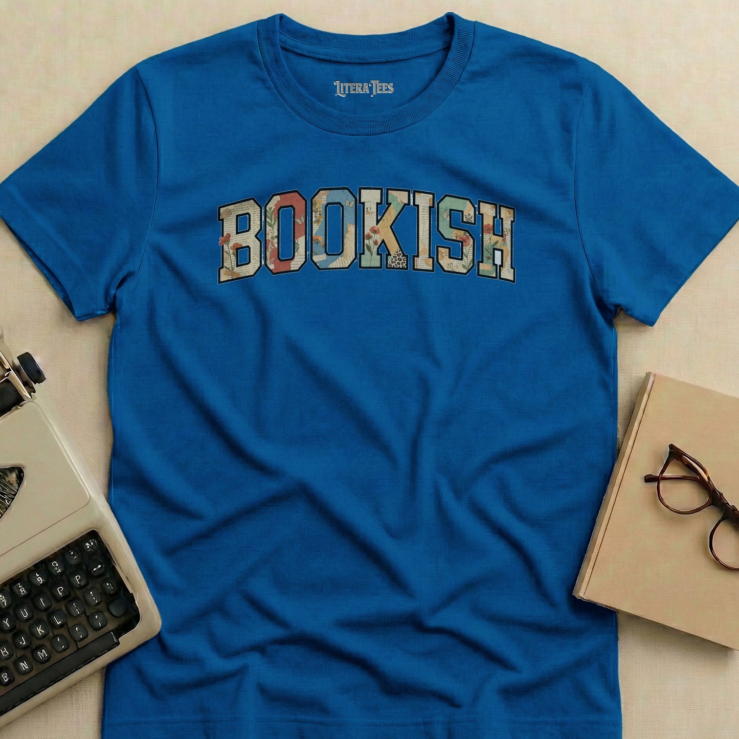 Blue t-shirt with "BOOKISH" text in floral pattern letters.