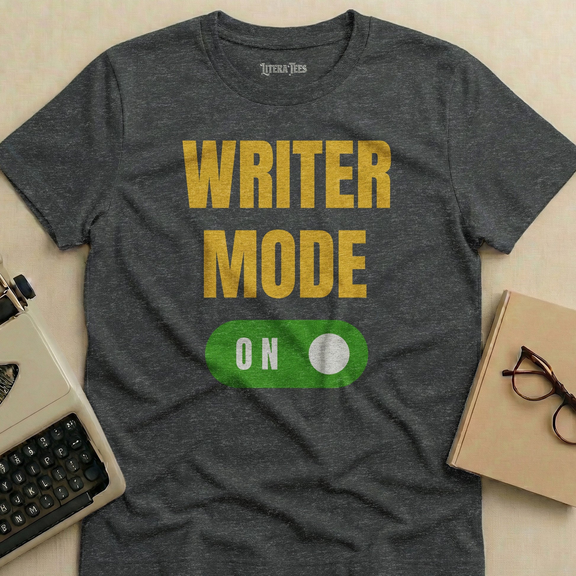 Dark gray t-shirt with "WRITER MODE ON" in large yellow and green text.