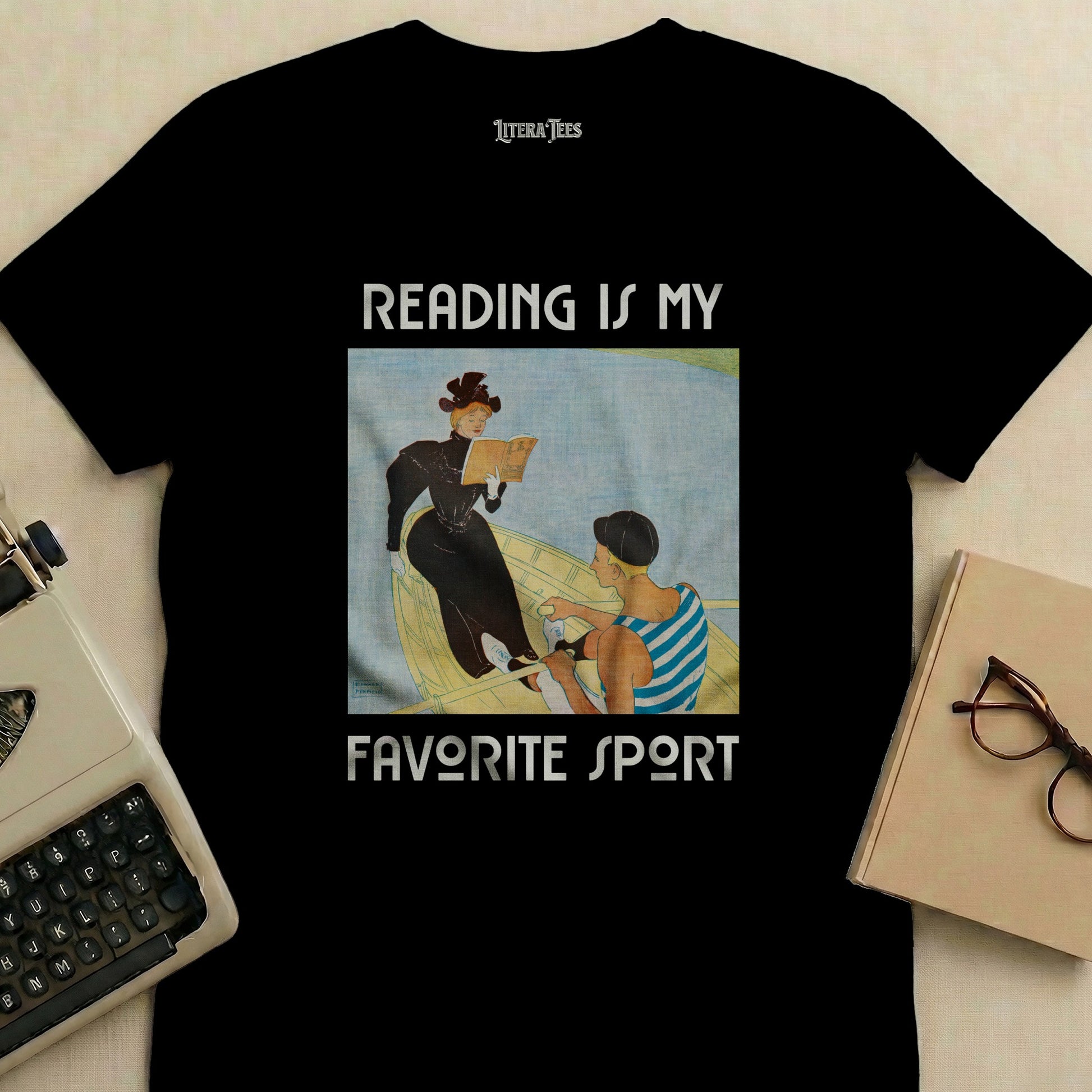 Black t-shirt with "Reading is My Favorite Sport" graphic featuring a woman in a boat reading.