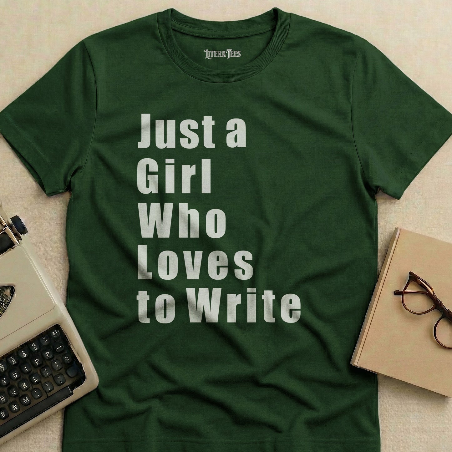 Dark green t-shirt with white text "Just a Girl Who Loves to Write".