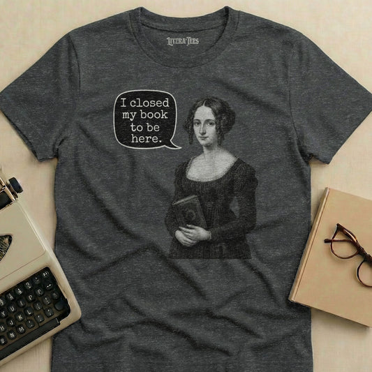 Dark grey t-shirt with an illustration reading "I closed my book to be here."