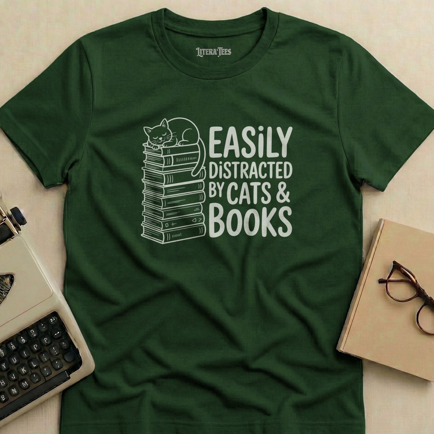 Green t-shirt with "Easily Distracted by Cats & Books" text and cat on books.