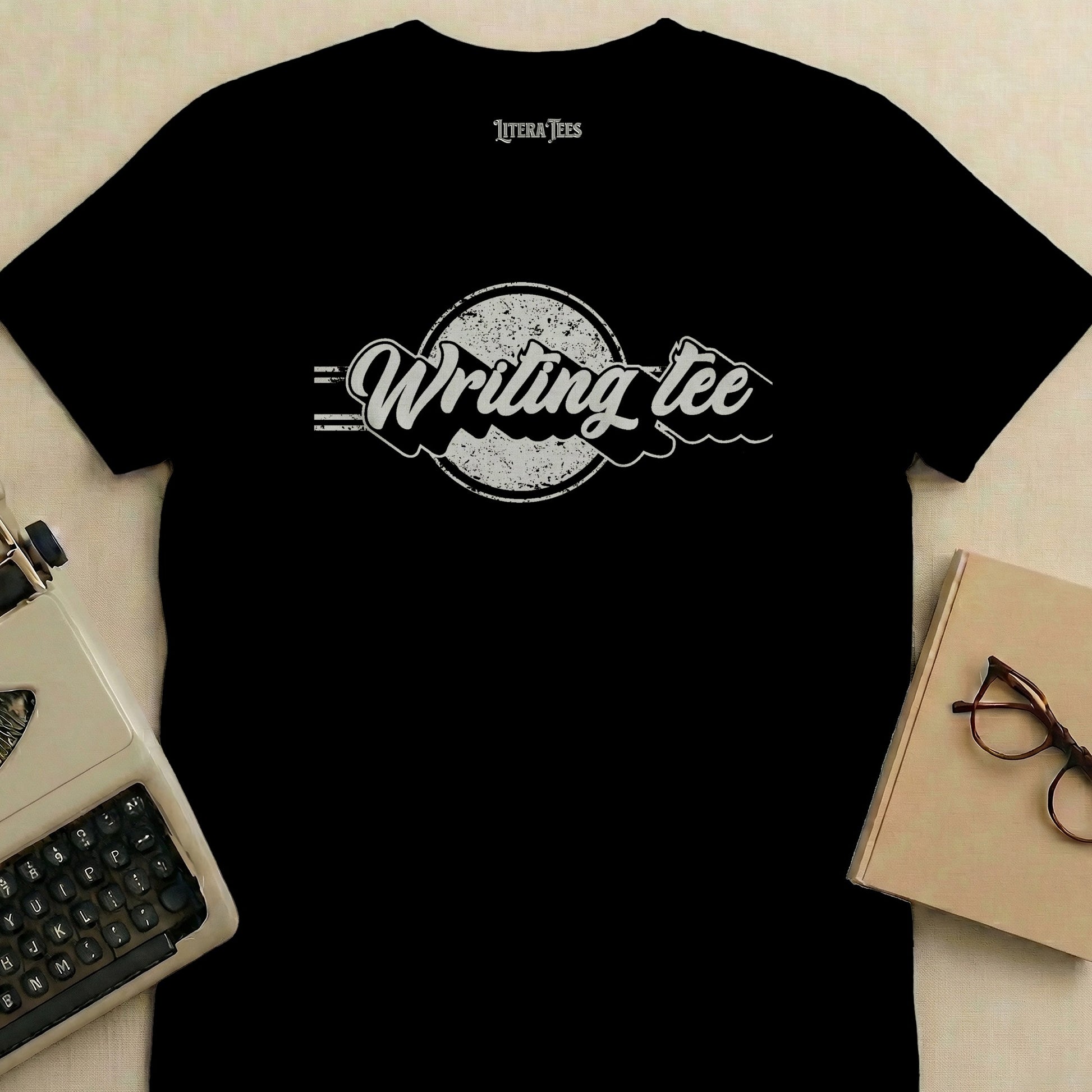 Black t-shirt with "Writing tee" logo and typewriter and glasses.