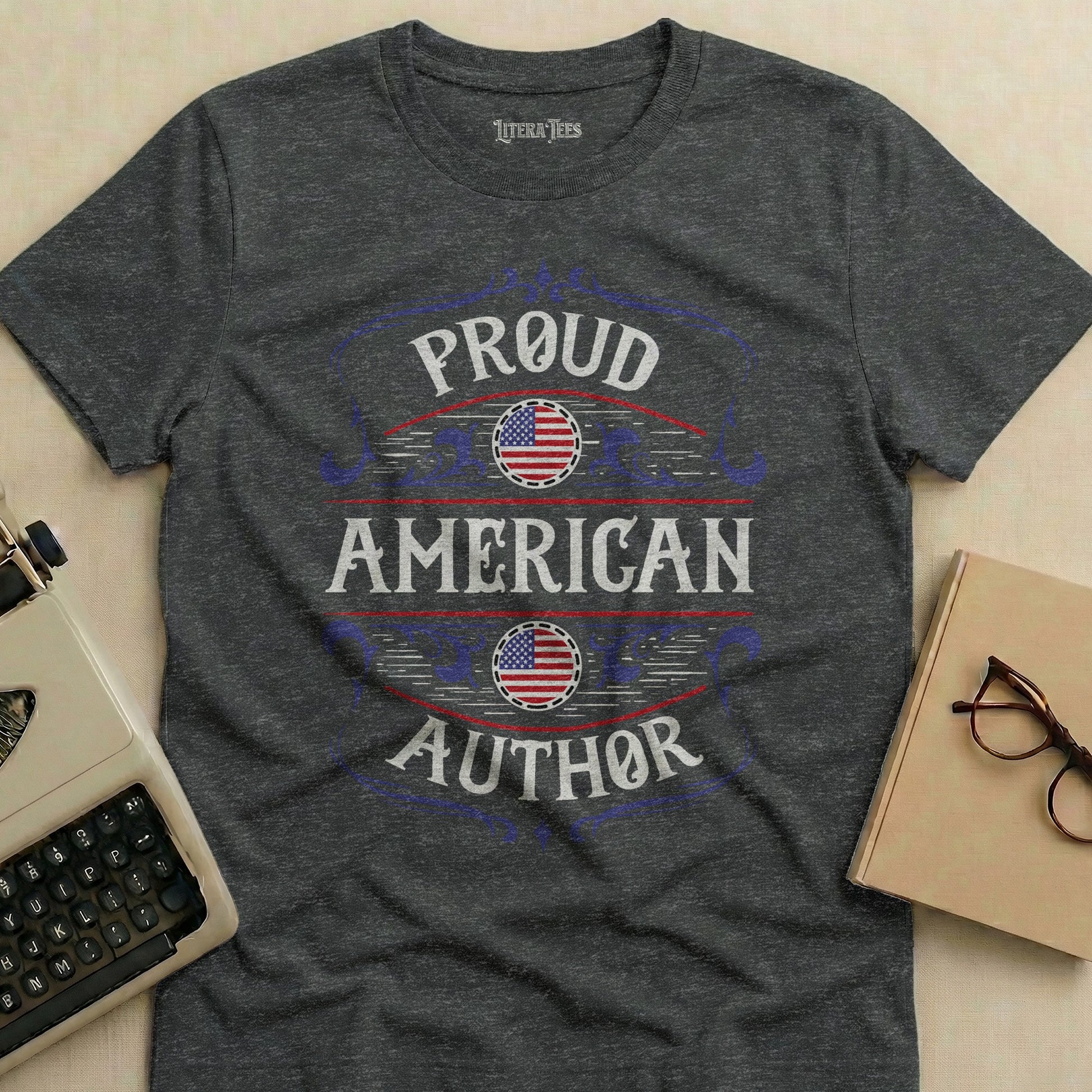 Proud American Author text on a dark grey t-shirt with American flag accents.