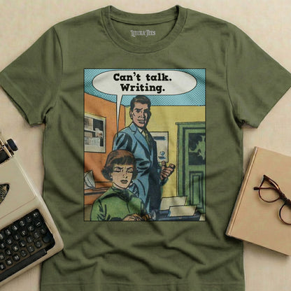 Olive green t-shirt with comic illustration of a man and woman, "Can't talk. Writing."