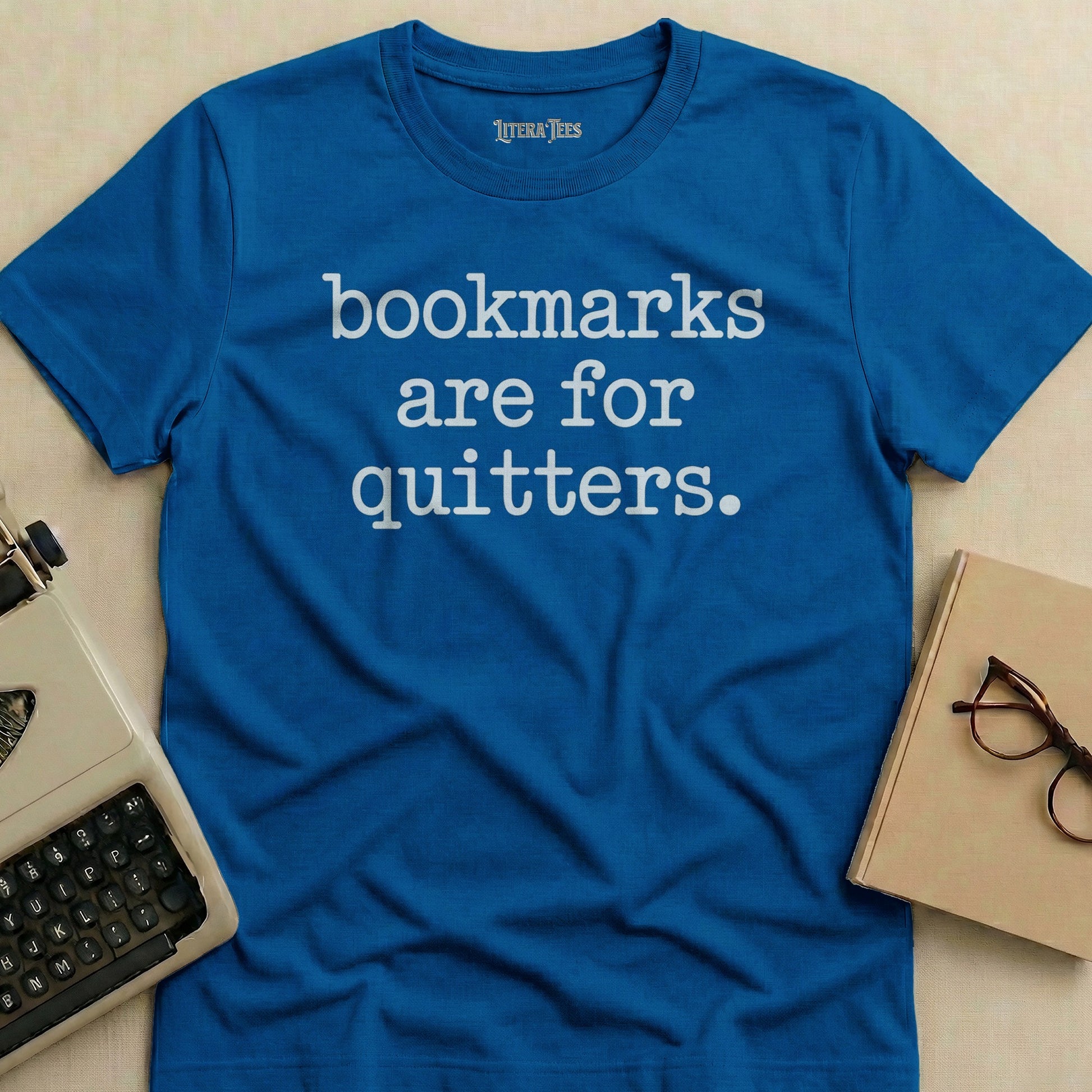 Blue t-shirt with white text "bookmarks are for quitters."