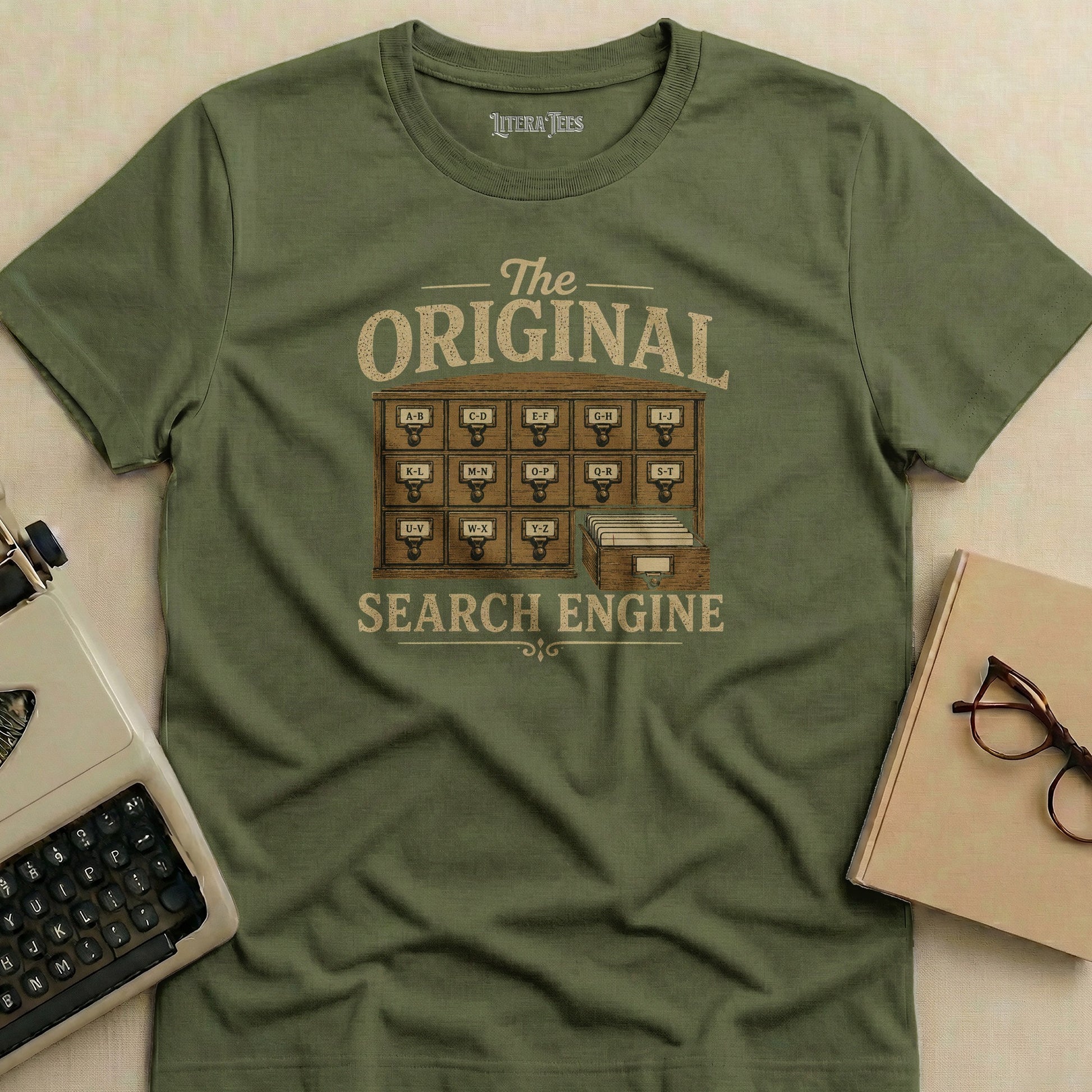 Olive green t-shirt with "The Original Search Engine" in vintage library card catalog style.