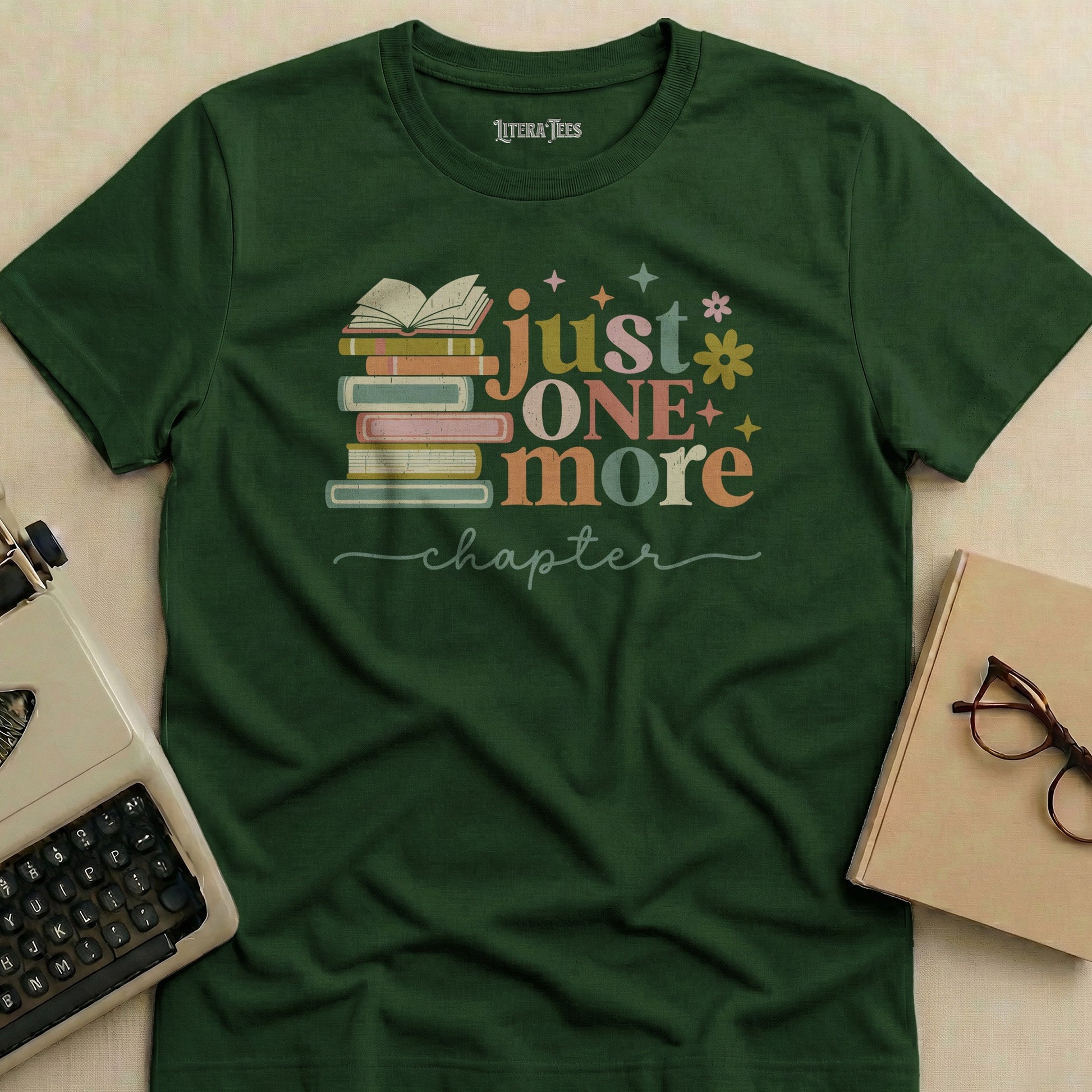 Green t-shirt with "just one more chapter" and stack of books design.